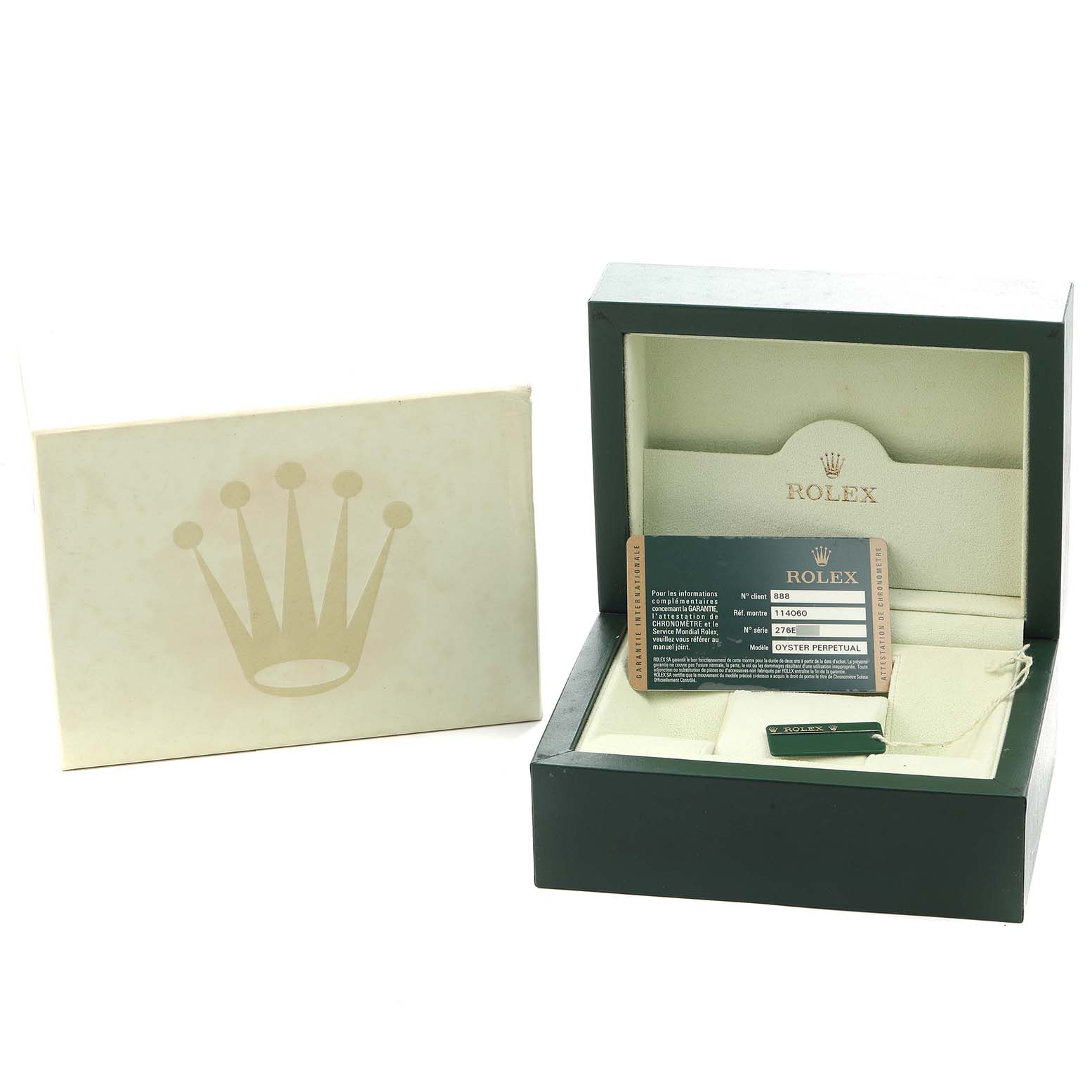 The image shows the watch box, warranty card, and packaging for a Rolex Submariner 114060 Men
s Stainless Steel Black Dial model.