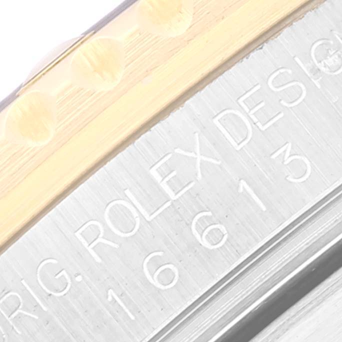 The image shows a close-up of the bezel and engraved case inscription on a Rolex Submariner 16613 Men's Steel and Gold (two tone) Black Dial 16613 Men's Steel and Gold (two tone) Black Dial watch.