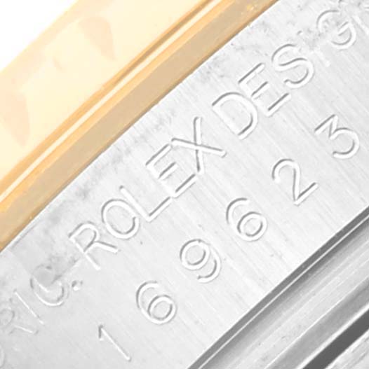 This close-up image shows the serial number and "Rolex Design" engraving on the side of a Rolex Yacht-Master 169623 Women's Steel and Gold (two tone) Grey Dial 169623 Women's Steel and Gold (two tone) Grey Dial watch case.