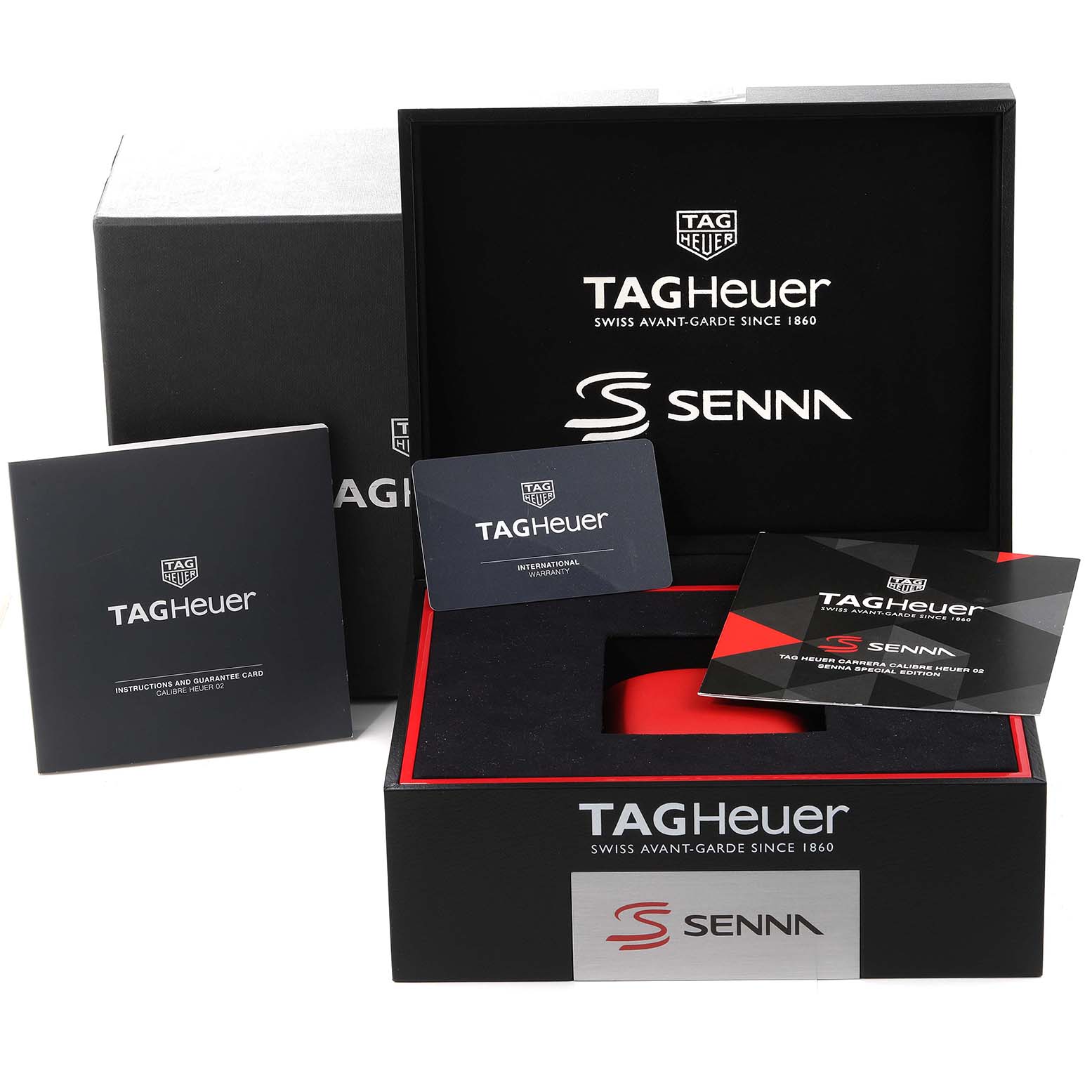 This image shows Tag Heuer Carrera CBG2013 Men's Stainless Steel Transparent Dial CBG2013 Men's Stainless Steel Transparent Dial packaging and accessories, including manuals and a warranty card, viewed from a top angle.