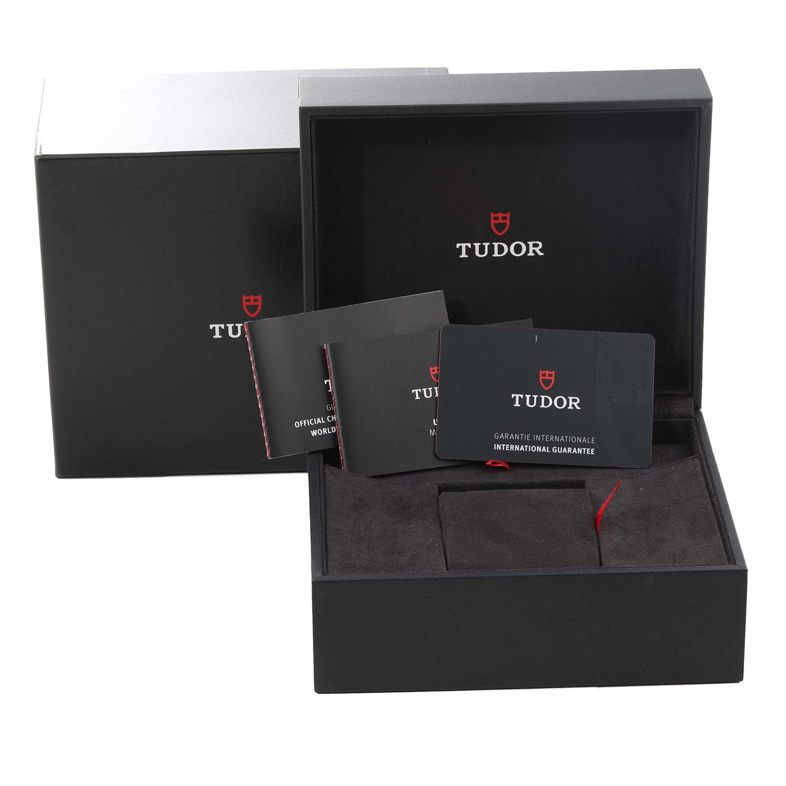 This image shows the packaging, warranty cards, and manuals of the Tudor Heritage Black Bay M79360N-0002 Men's Stainless Steel Silver Dial M79360N-0002 Men's Stainless Steel Silver Dial watch.