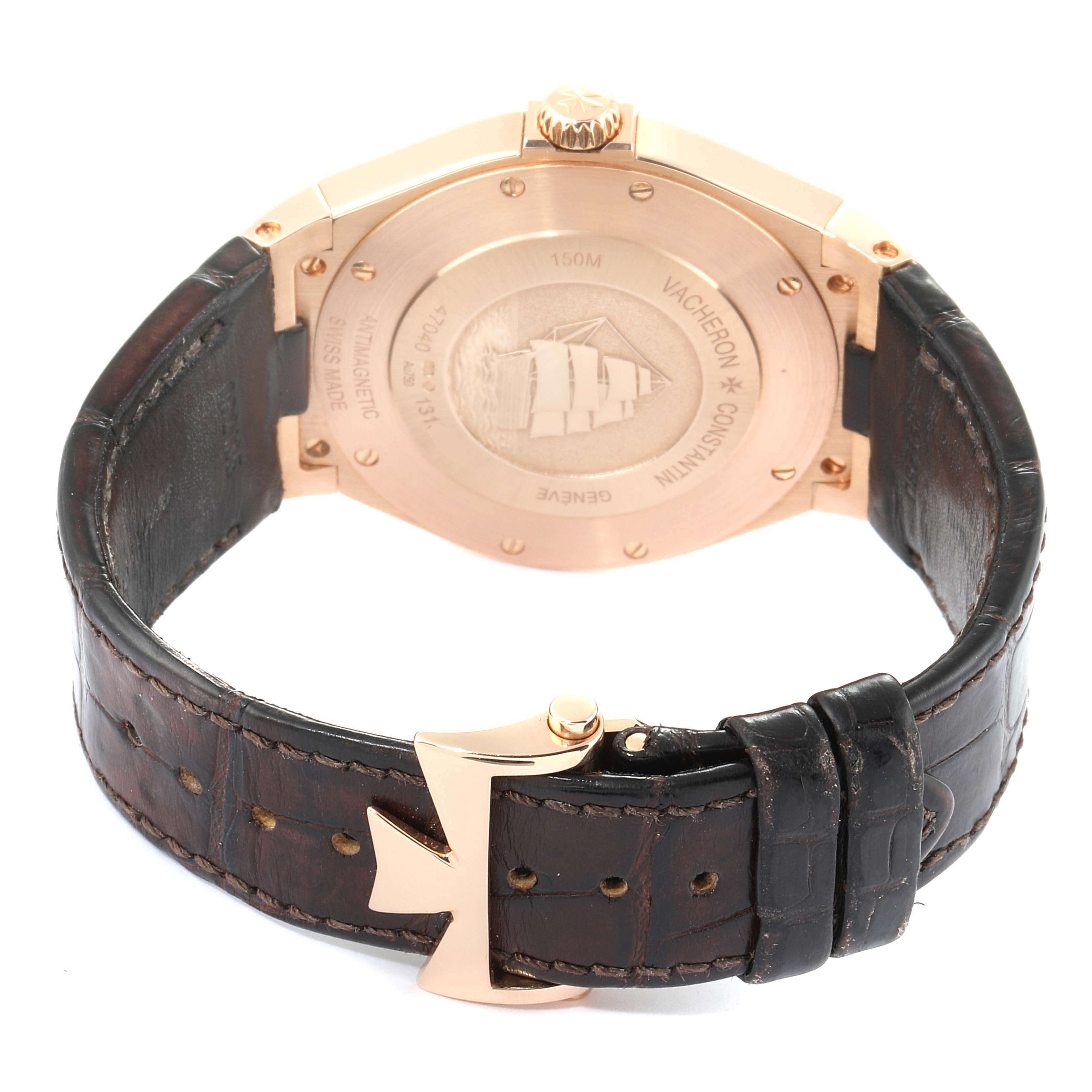 The image shows the back of a Vacheron Constantin Overseas 47040/000R-9666 Men's Rose Gold Black Dial 47040/000R-9666 Men's Rose Gold Black Dial watch with a leather strap and cross-shaped clasp.