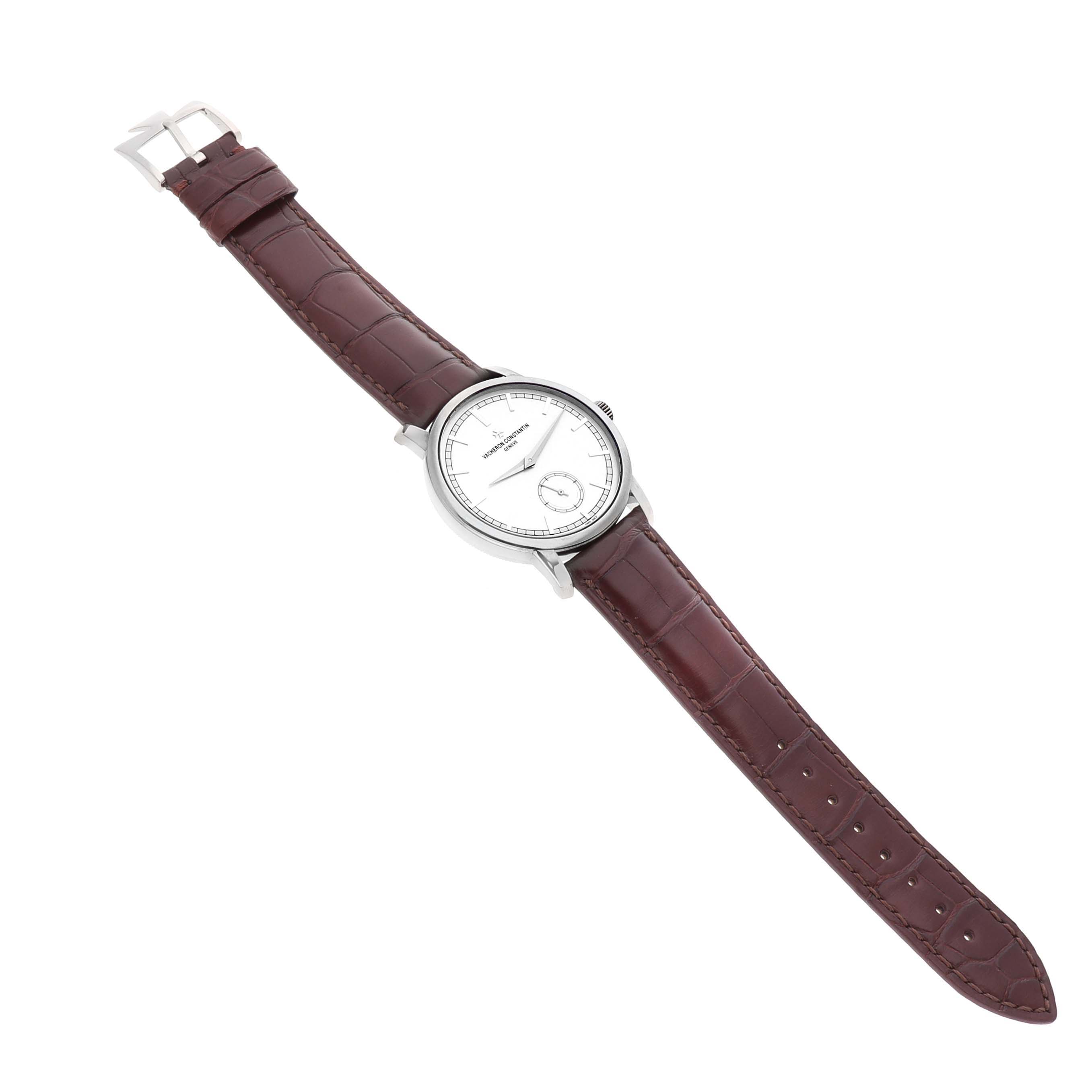 The Vacheron Constantin Traditionnelle 82172G Men's White Gold Silver Dial watch is shown from a top view, highlighting the watch face, case, brown leather strap, and buckle.