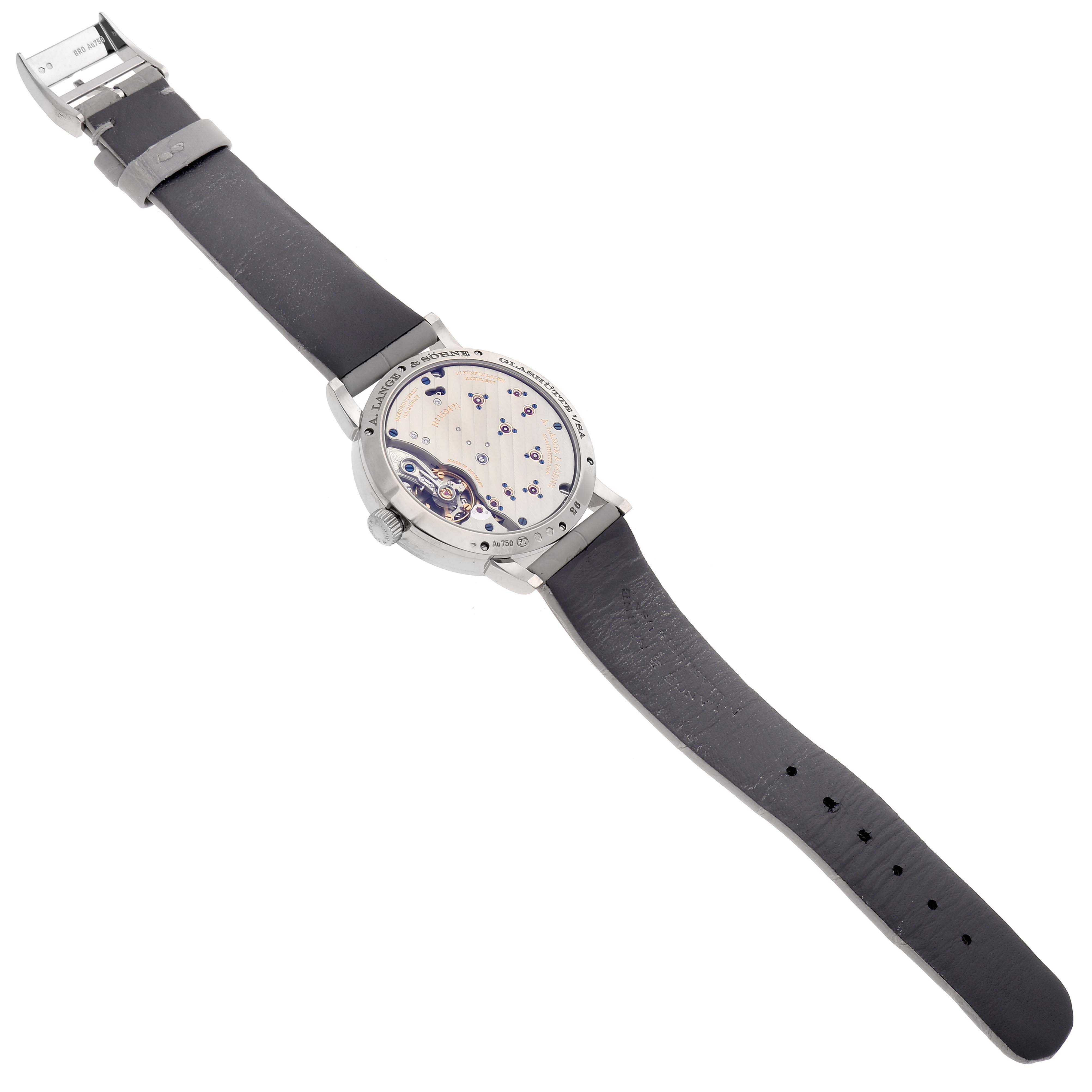 The image shows the back of the A. Lange & Sohne Lange 1 181.038 Men's White Gold Grey Dial watch at a slight angle, highlighting its movement and strap.