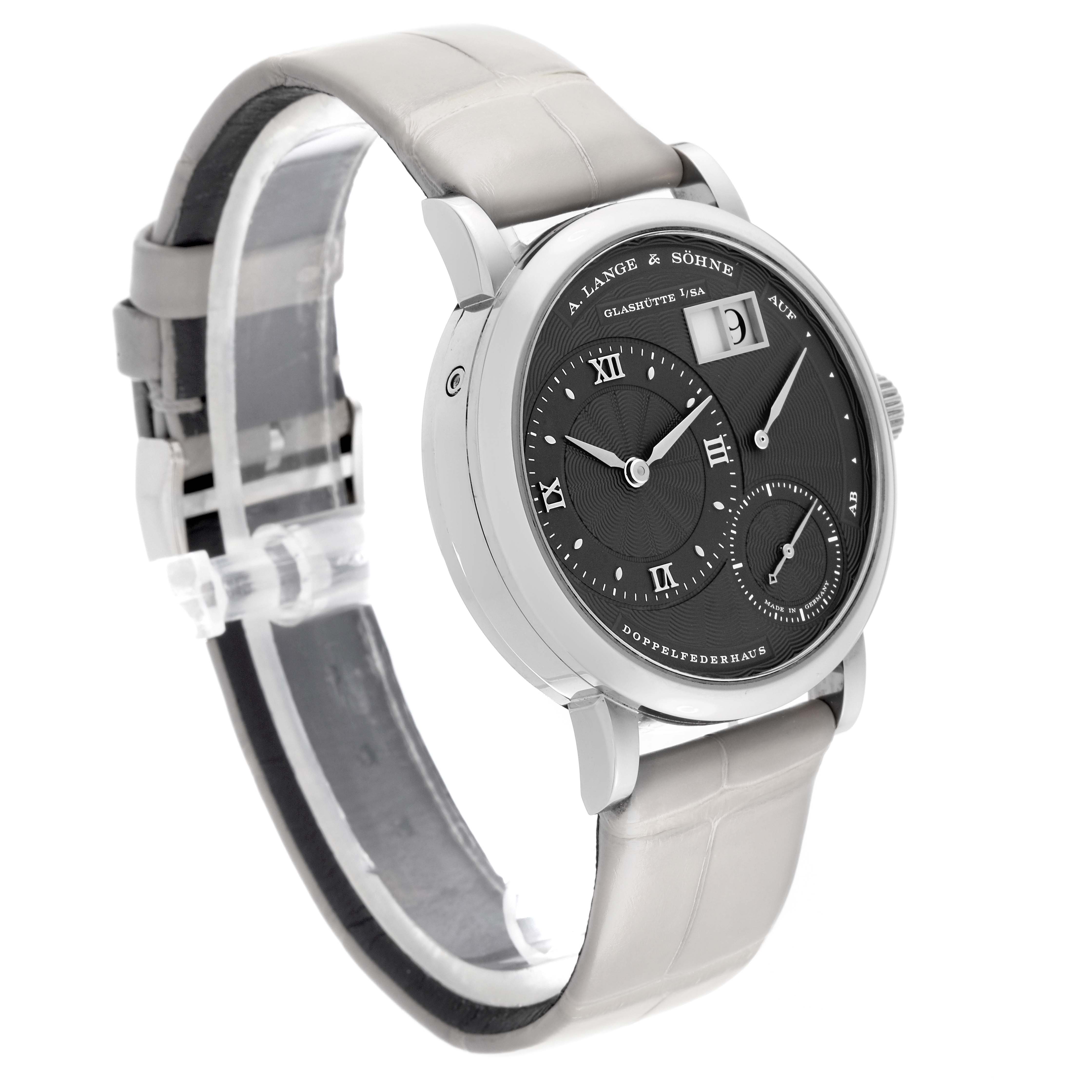 The image shows a side angle of the A. Lange & Sohne Lange 1 181.038 Men's White Gold Grey Dial watch, highlighting its black dial, silver markers, and leather strap.