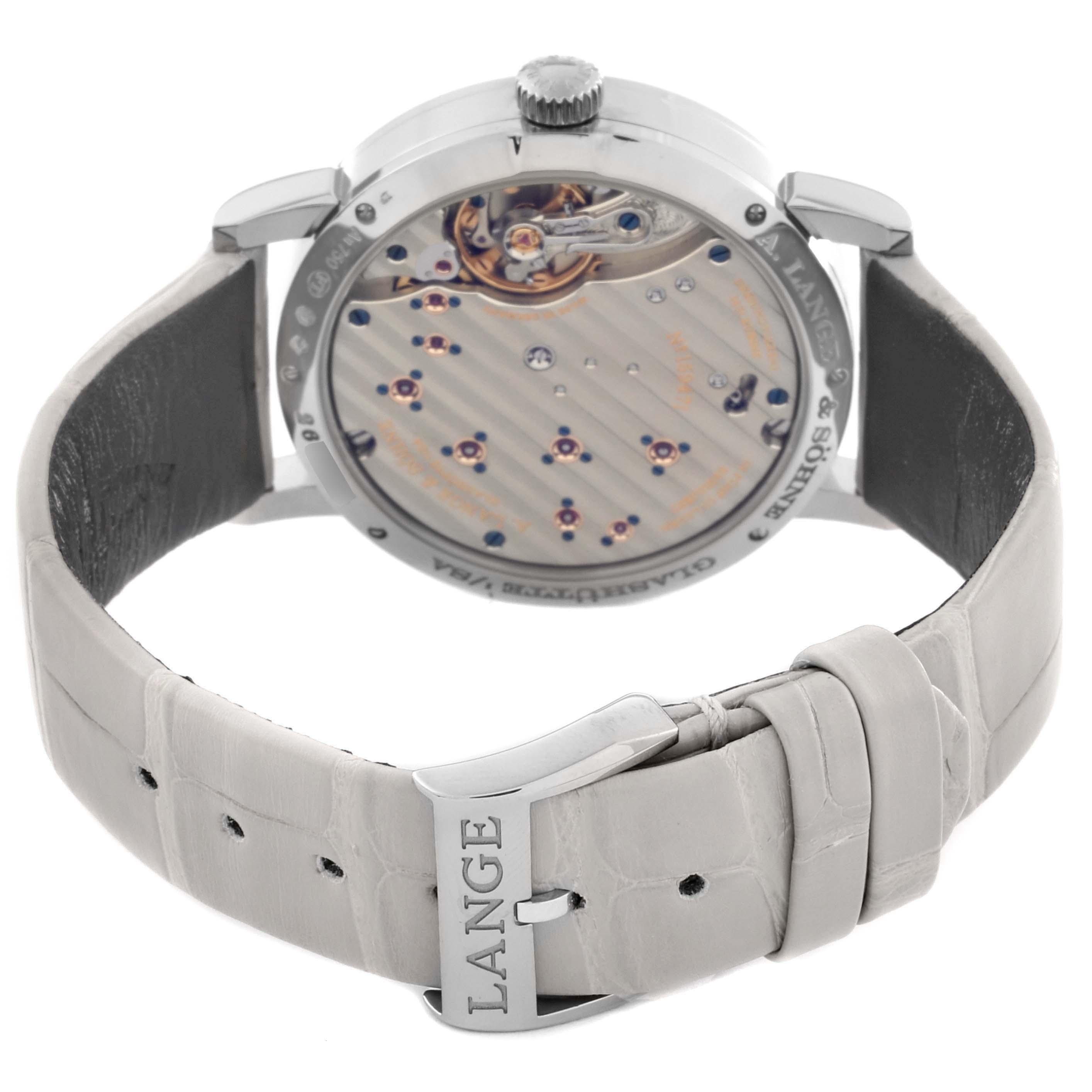 The image shows the back view of a Lange 1 watch by A. Lange & Söhne, highlighting the movement and the leather strap.