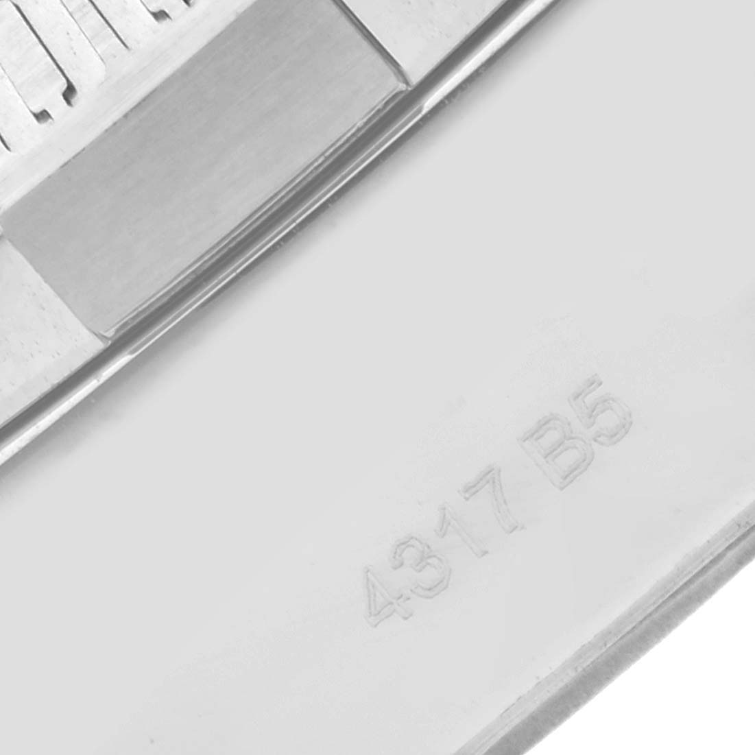 This close-up image shows the case back of a Breitling Avenger A13371 Men's Stainless Steel Black Dial A13371 Men's Stainless Steel Black Dial watch, featuring serial number engraving.