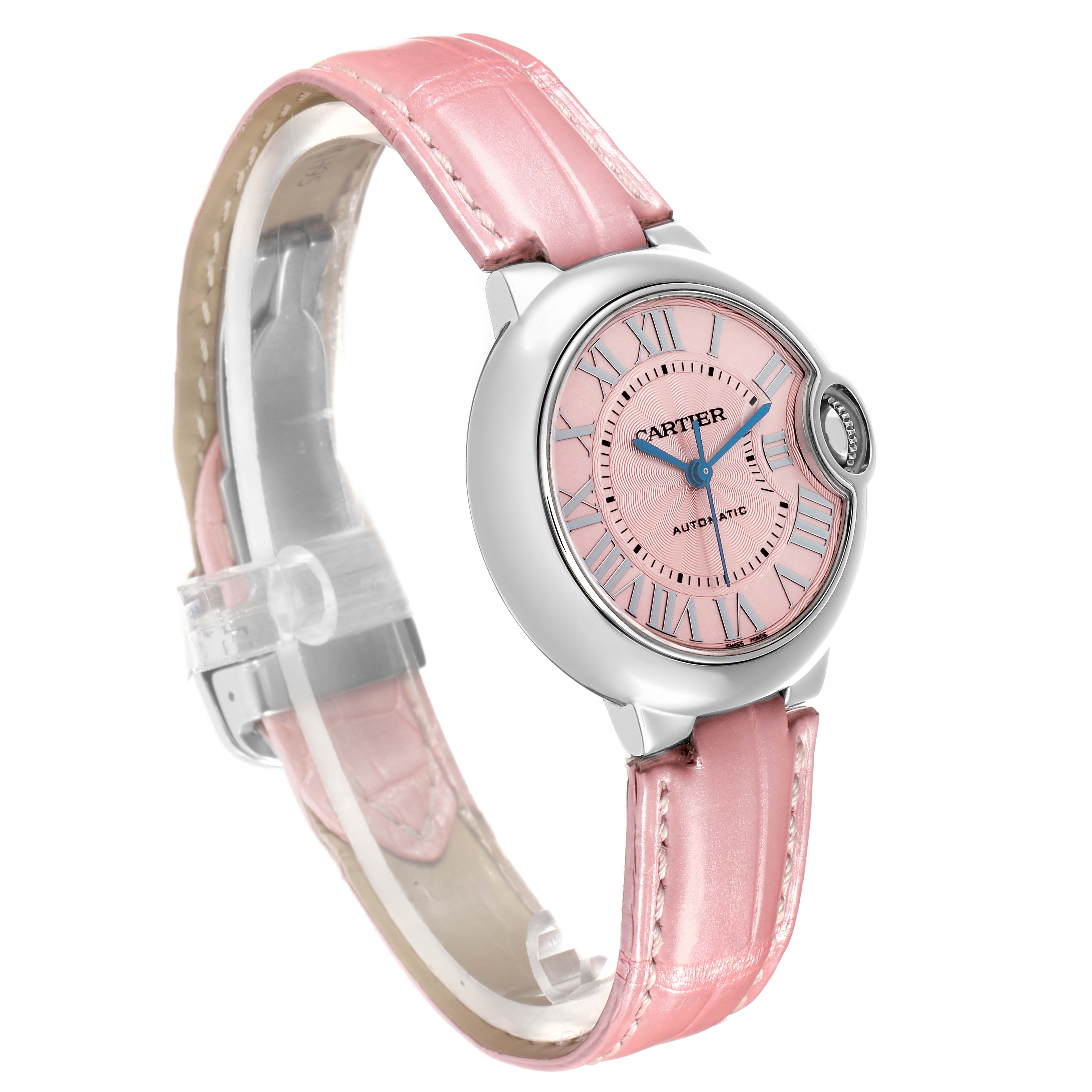 The Cartier Ballon Bleu WSBB0002 Women
s Stainless Steel Pink Dial watch is shown at a three-quarter angle, highlighting its pink dial, Roman numerals, and pink leather strap.