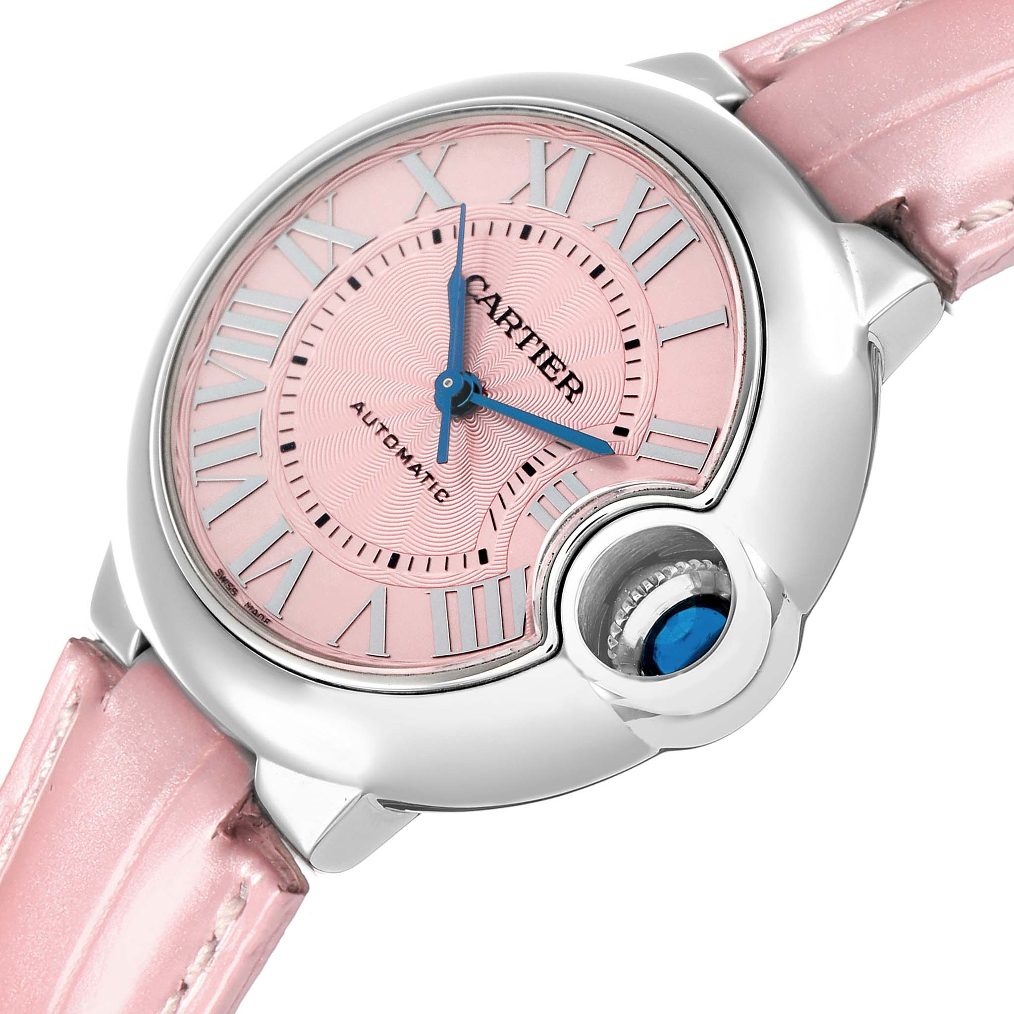 The Cartier Ballon Bleu WSBB0002 Women
s Stainless Steel Pink Dial watch is shown at a slight angle, highlighting its pink dial, blue hands, and signature crown with a blue cabochon.