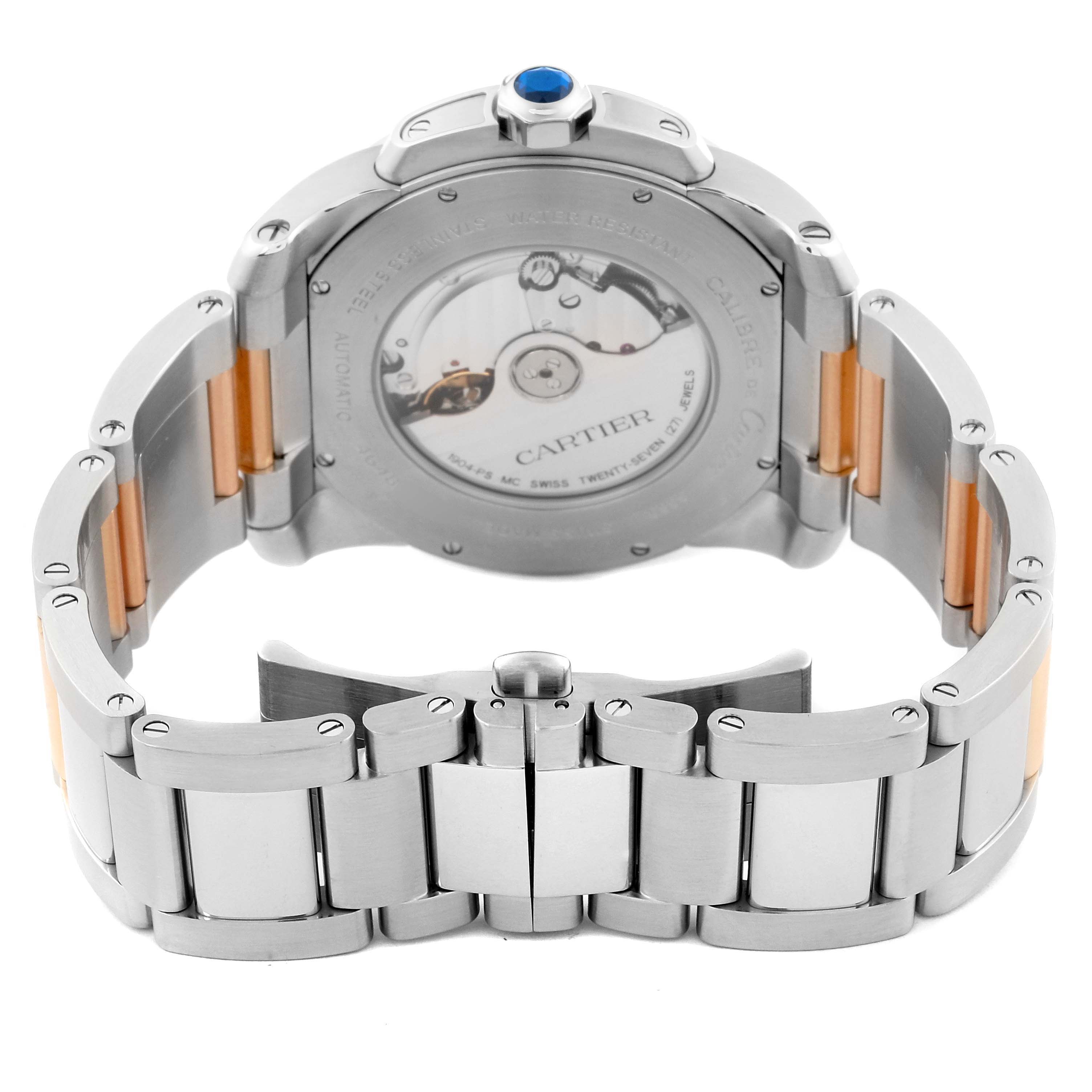 The image shows the back view of a Calibre de Cartier watch by Cartier, highlighting the movement and metal bracelet.