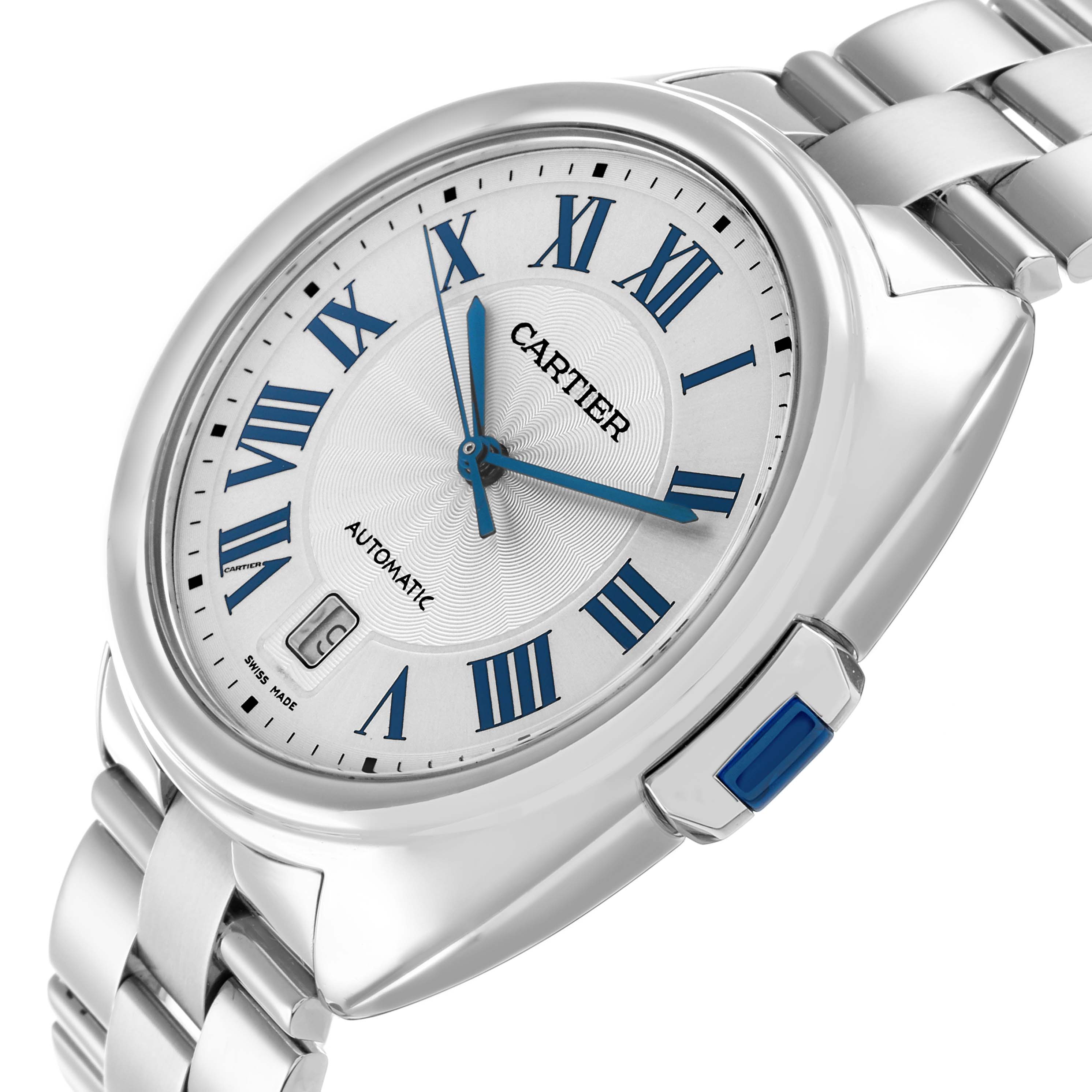 The Cartier Clé watch is shown at a tilted side angle, highlighting its dial, crown, and bracelet.