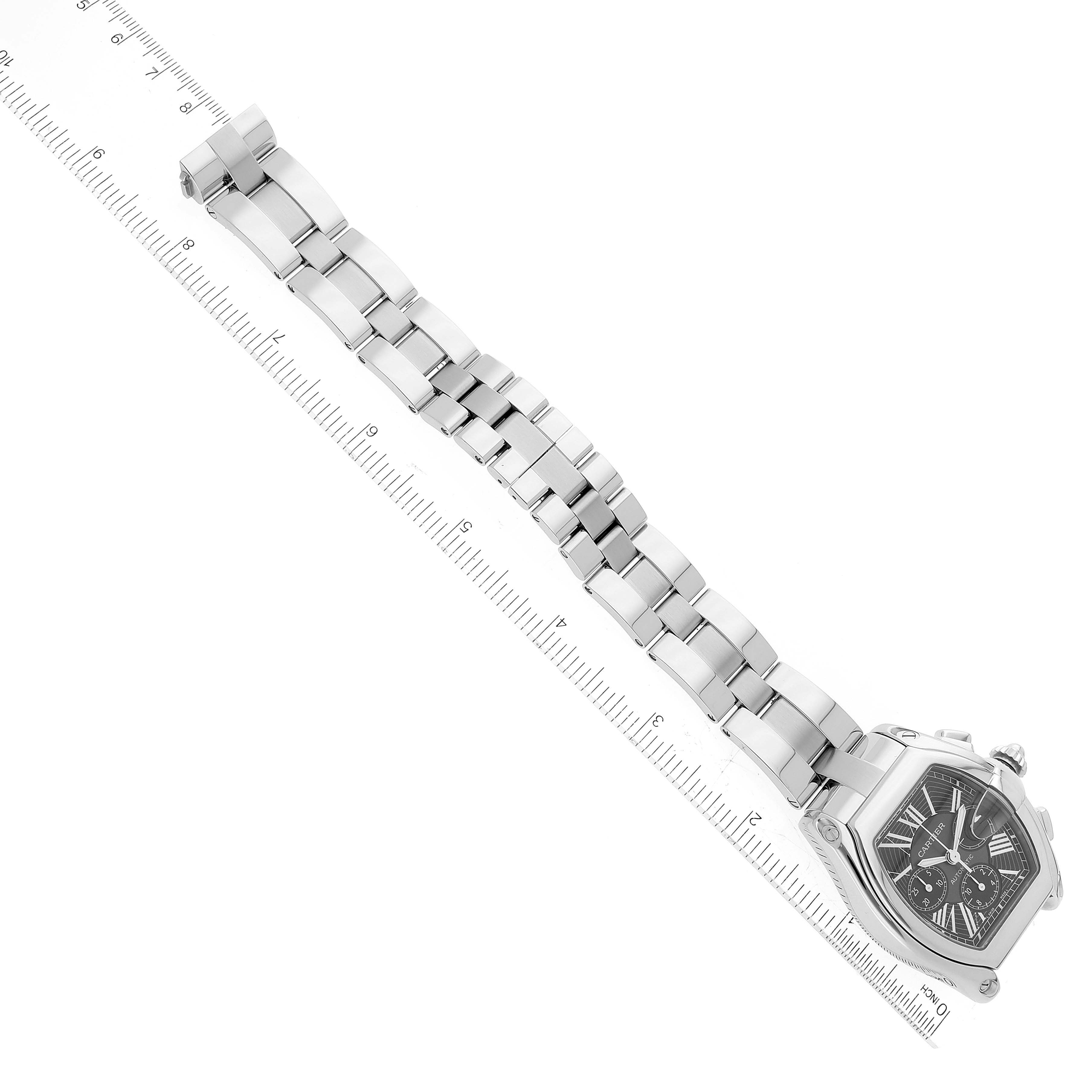 The Cartier Roadster W62020X6 Men's Stainless Steel Black Dial W62020X6 Men's Stainless Steel Black Dial model watch is shown from a top-down angle, displaying its face and full metal bracelet alongside a measurement ruler.