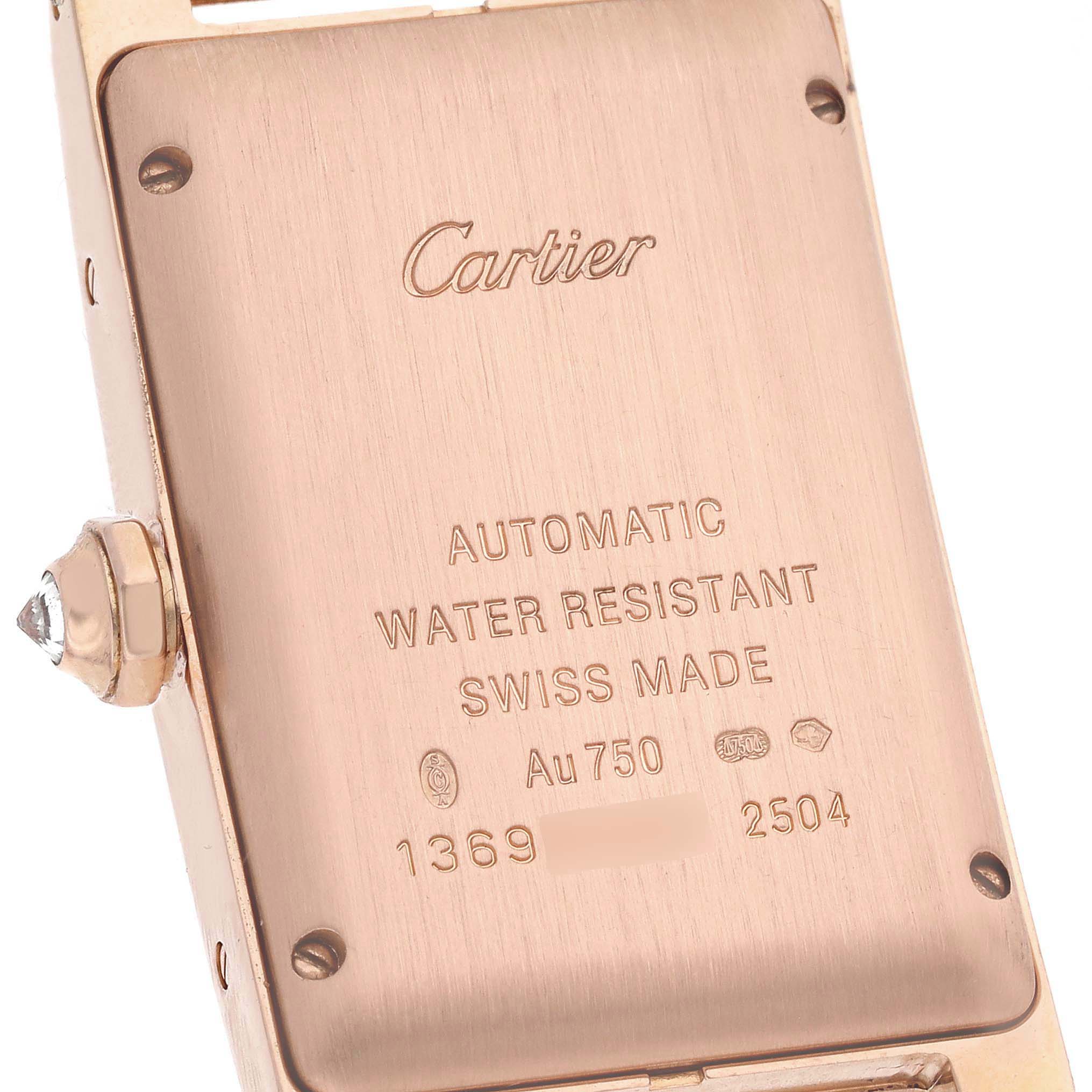 This image shows the back case and crown of a Cartier Tank Américaine watch, displaying details like the brand name, material, and serial number.