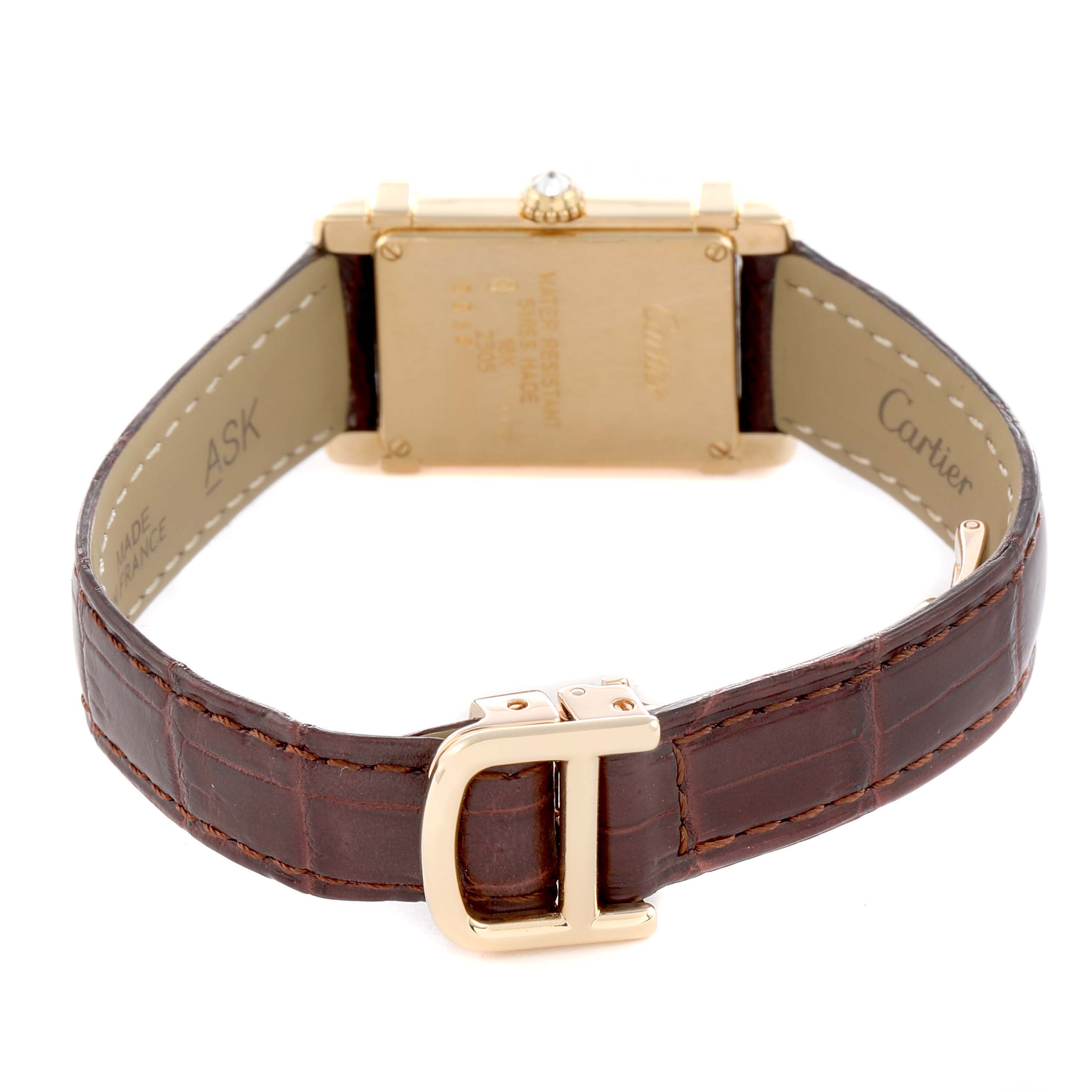 The image shows the back view of a Cartier Tank Louis 2305 Women
s Yellow Gold Silver Dial watch, highlighting its leather strap and buckle.