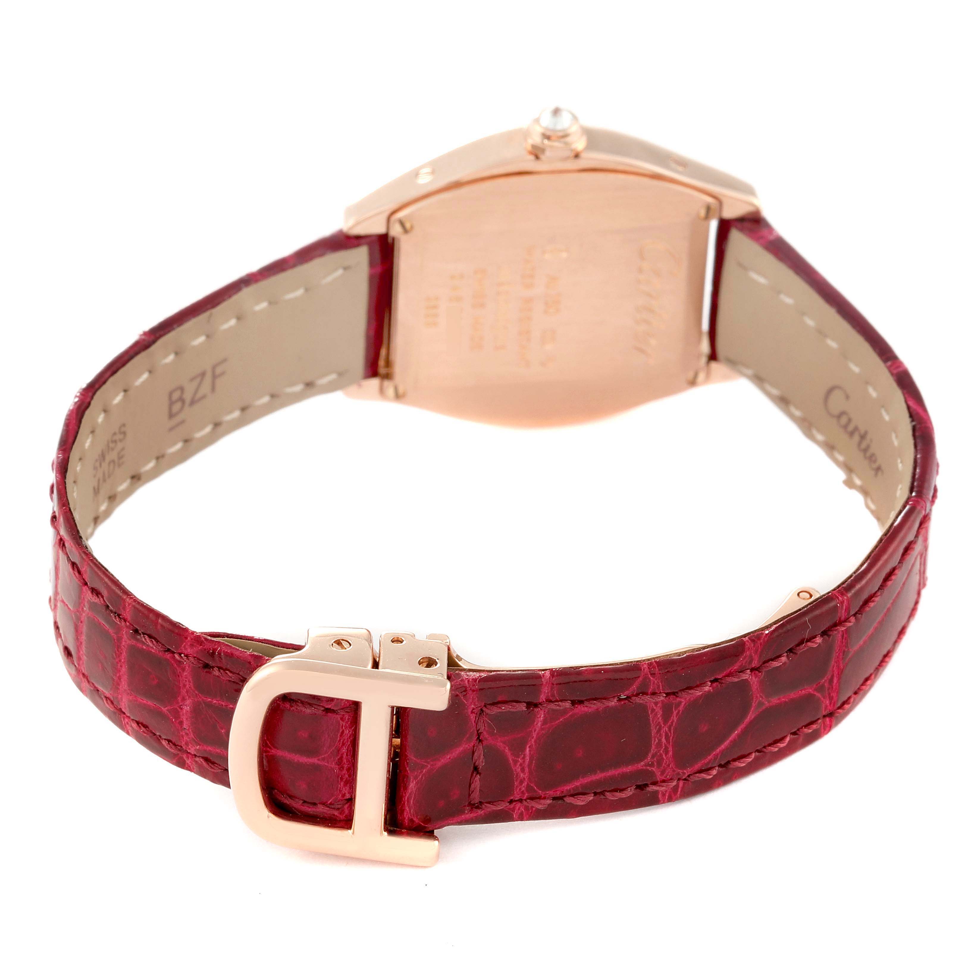 This image shows the back view of a Cartier Tortue WA501006 Women
s Rose Gold Silver Dial WA501006 Women
s Rose Gold Silver Dial watch with an open red leather strap and a gold clasp buckle.