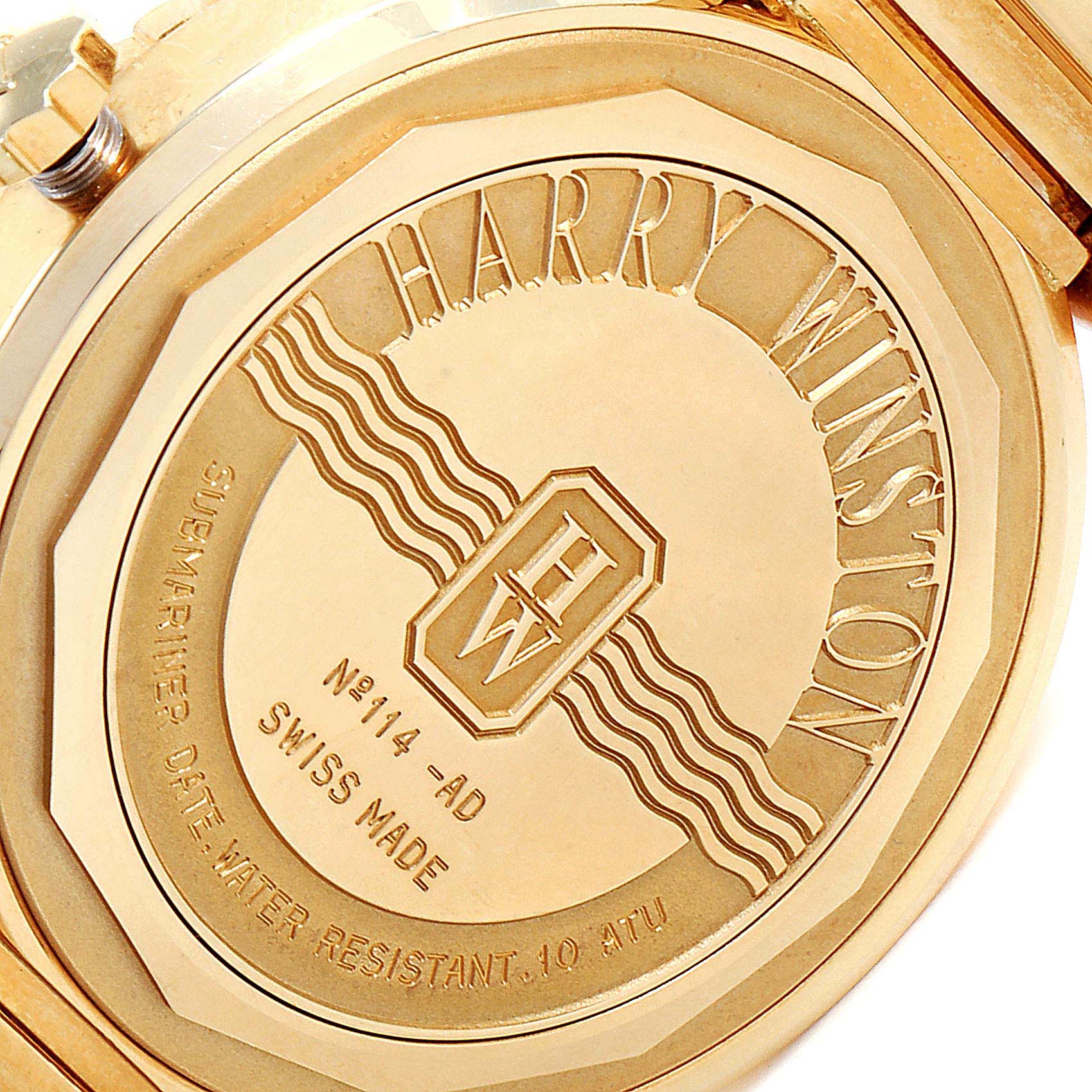 This is a close-up of the back case of a Harry Winston N114-AD Men's Yellow Gold Grey Dial N114-AD Men's Yellow Gold Grey Dial Submariner Ocean 38mm 18K Yellow Gold Men's Watch.