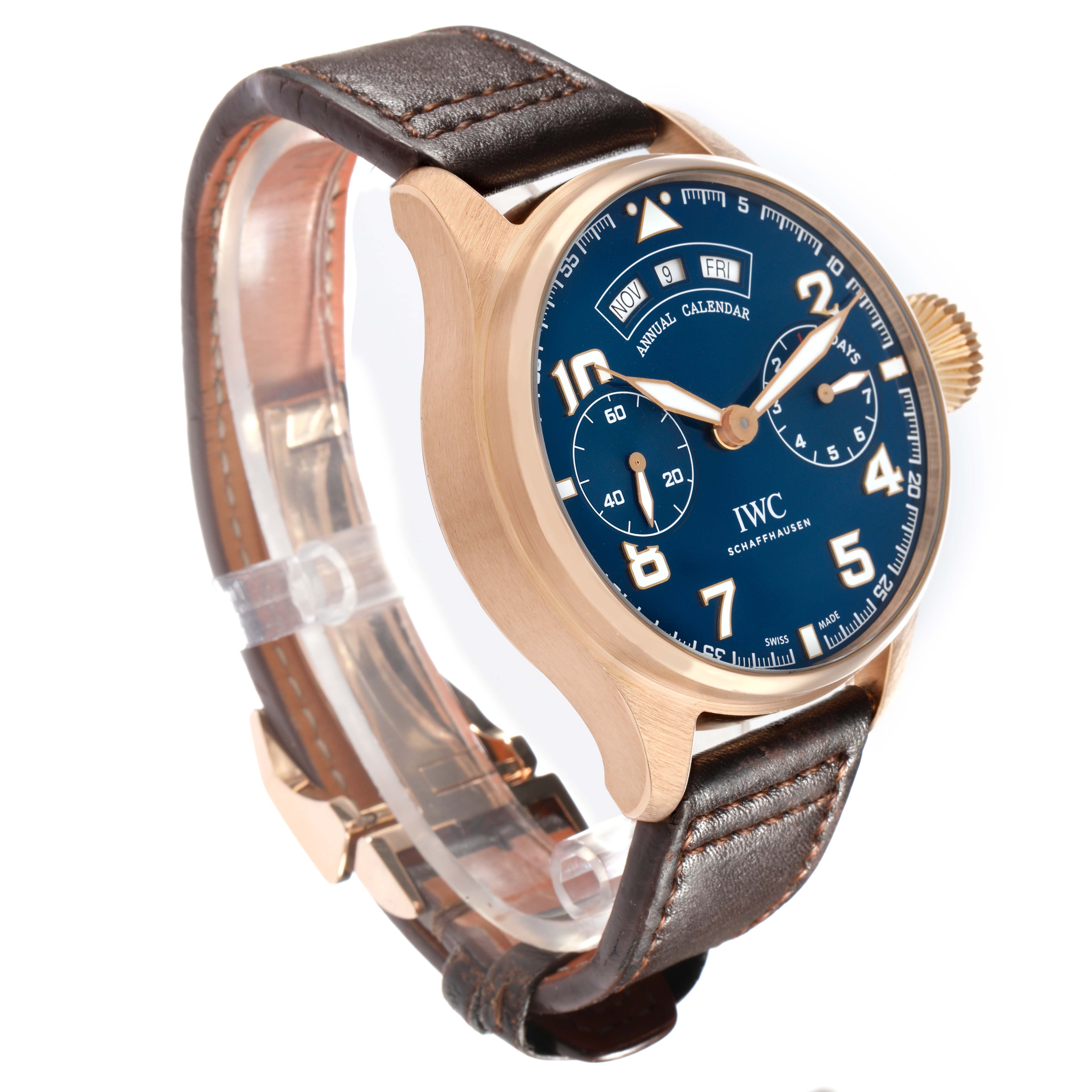 The IWC Pilot IW502701 Men
s Rose Gold Blue Dial watch is shown at an angle displaying the dial, case, crown, and brown leather strap.
