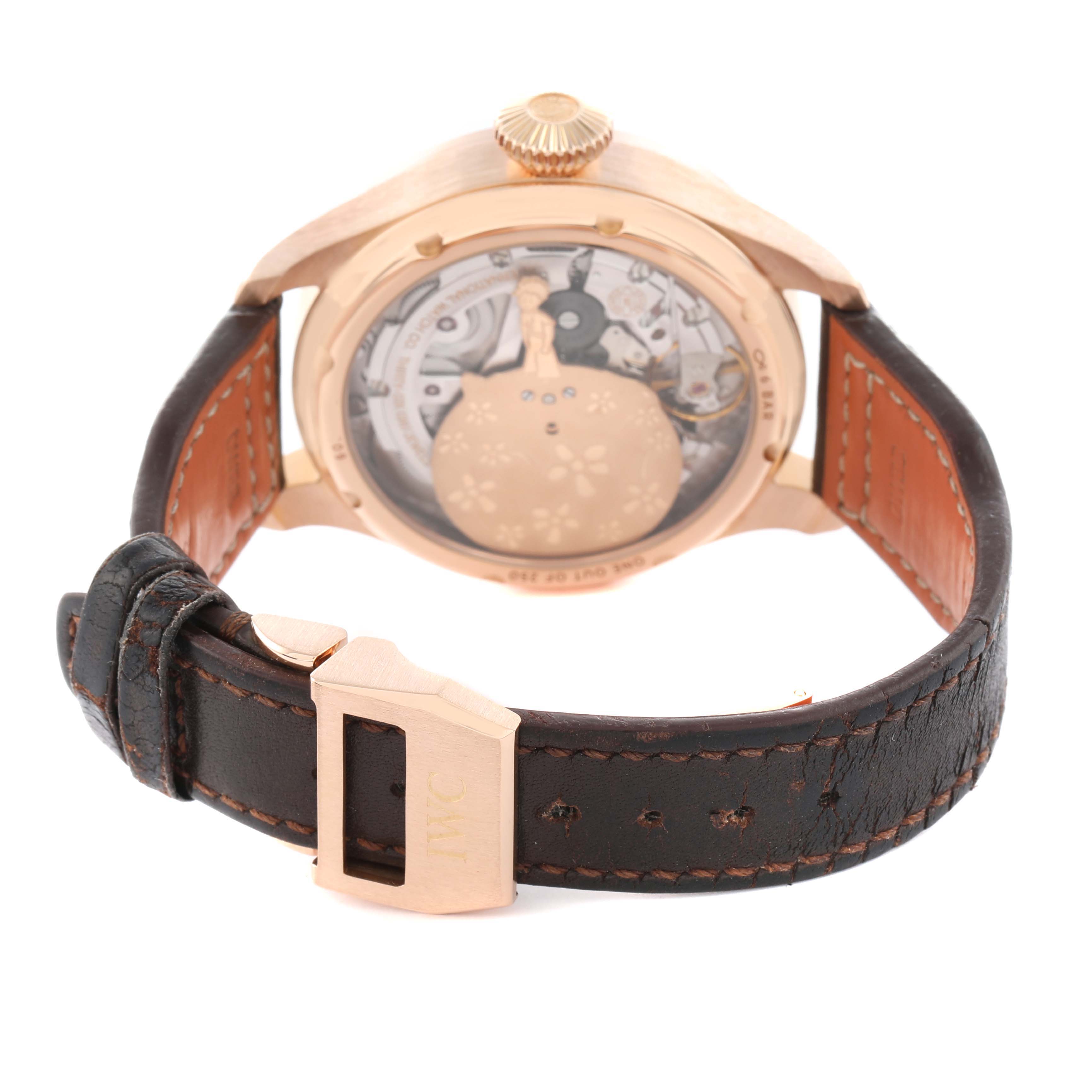 The IWC Pilot IW502701 Men
s Rose Gold Blue Dial watch is shown from the back, displaying the case back, crown, and leather strap clasp.