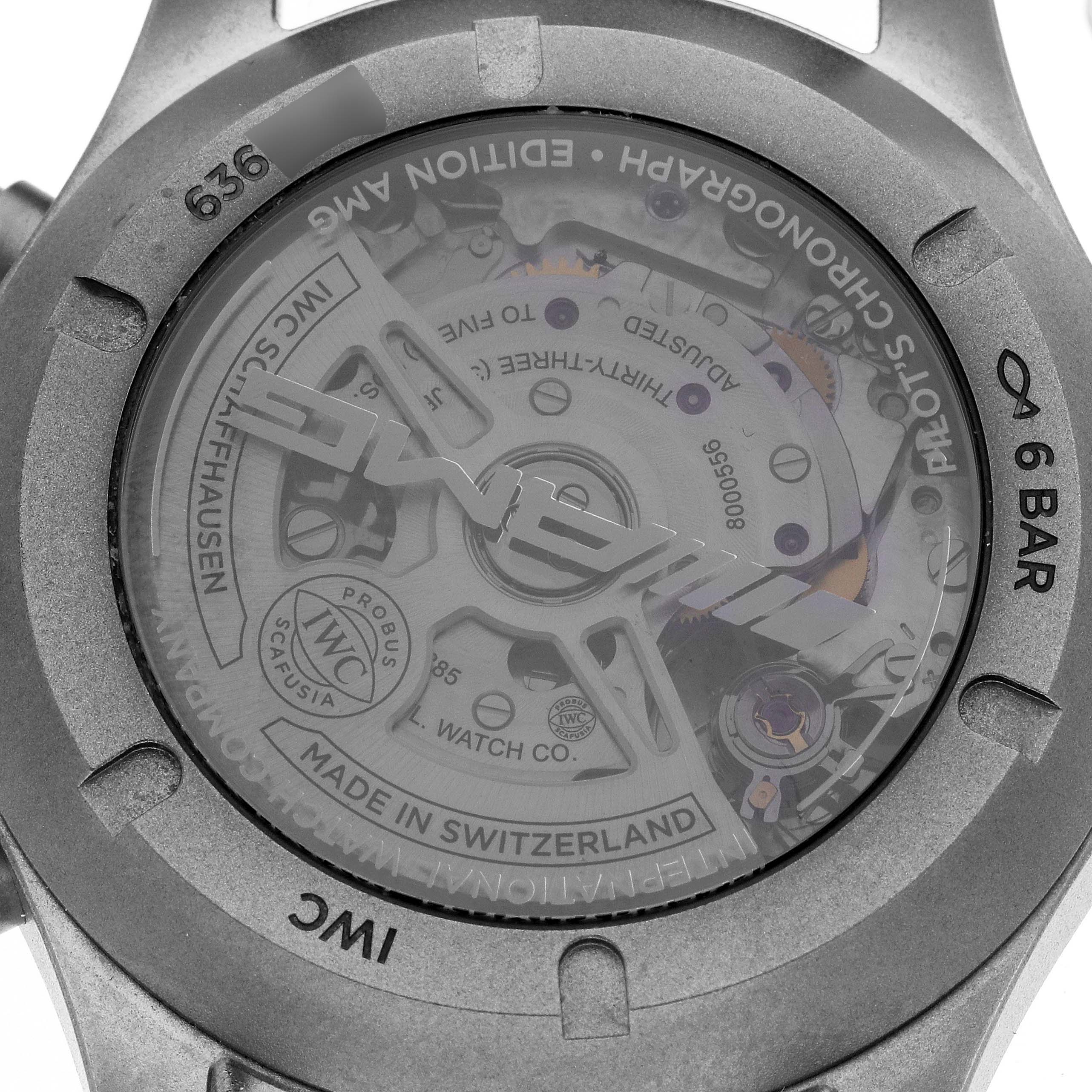 This image shows the back case of the IWC Pilot IW377903 Men
s Titanium Grey Dial IW377903 Men
s Titanium Grey Dial model watch, revealing the inner mechanical movement and engravings.