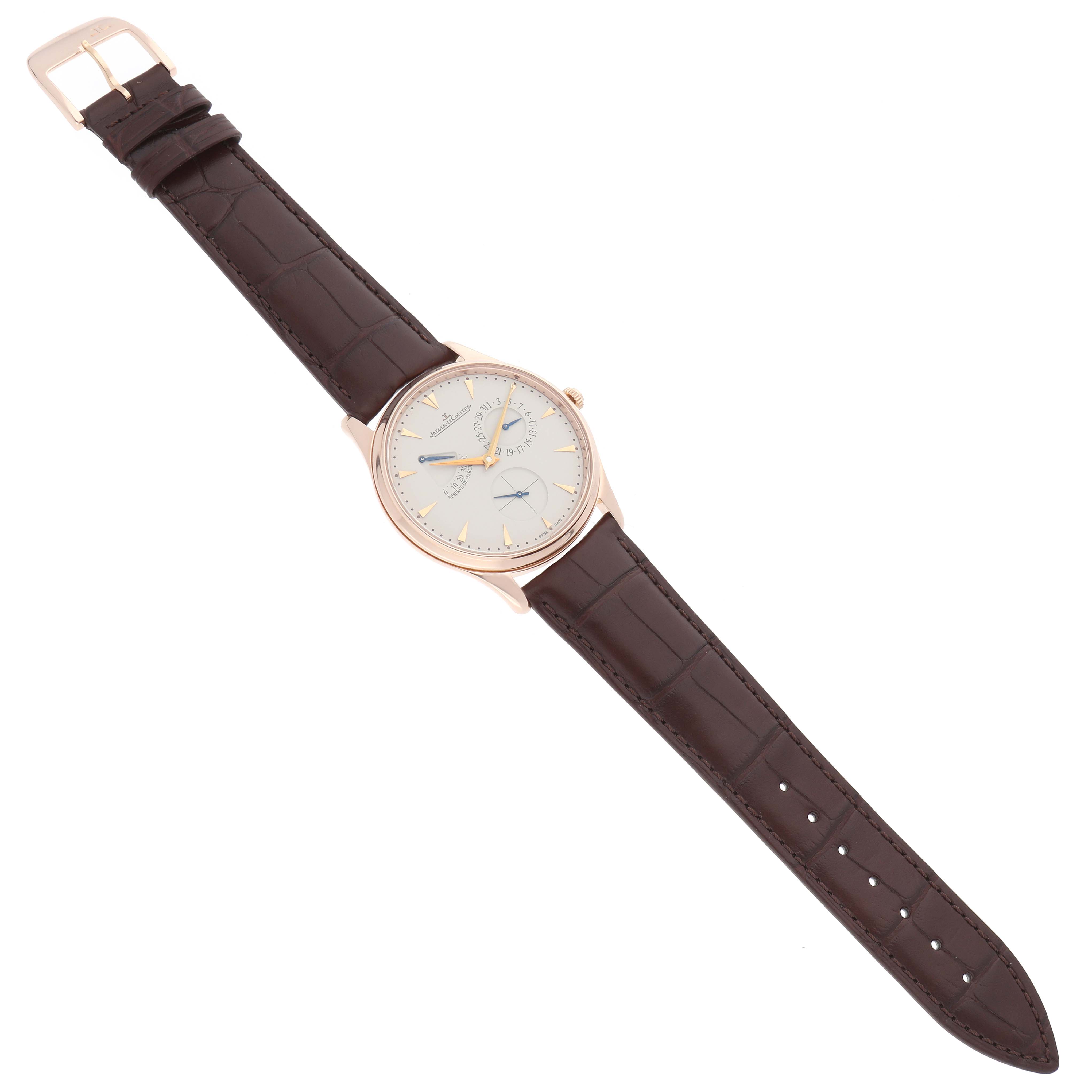 The Jaeger LeCoultre Master Q1372520 Men
s Rose Gold Beige Dial watch is shown from a top-down angle, displaying its dial, case, and full leather strap.