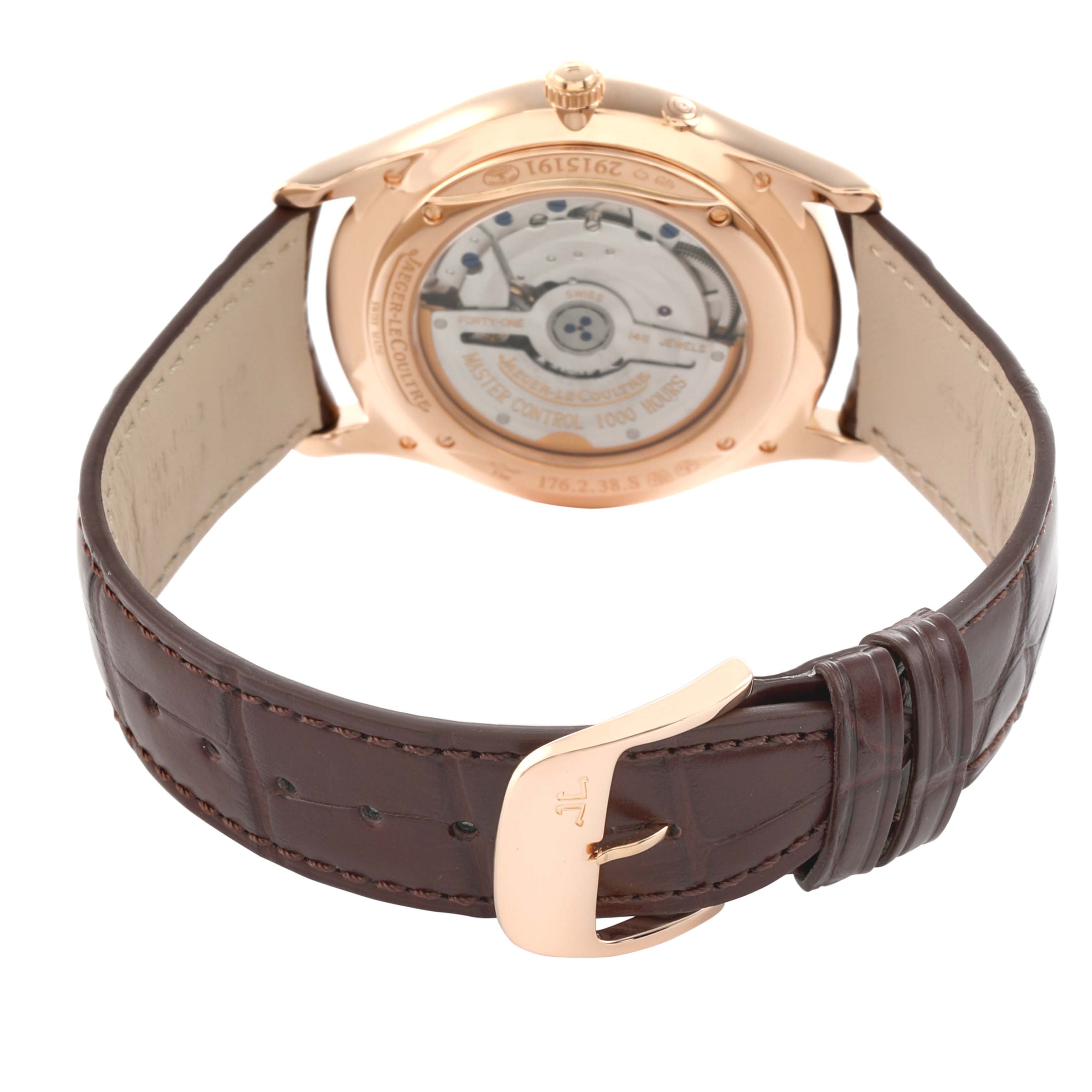 The image shows the back view of a Jaeger LeCoultre Master Q1372520 Men
s Rose Gold Beige Dial model, highlighting the case back and movement, with a leather strap and buckle.
