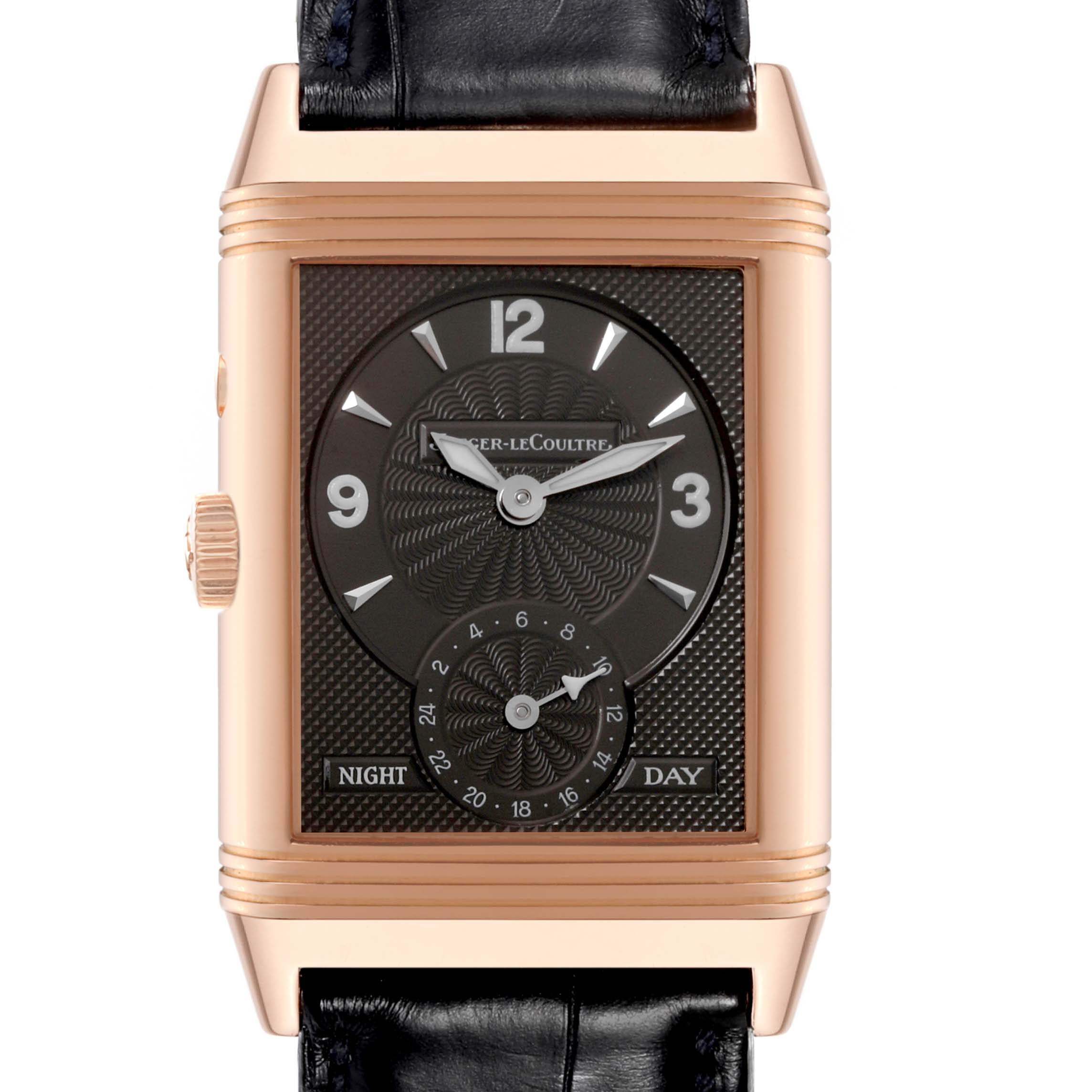 The image shows a front view of a Jaeger-LeCoultre Reverso watch with a black strap and rose gold case, displaying time and day/night indicators.