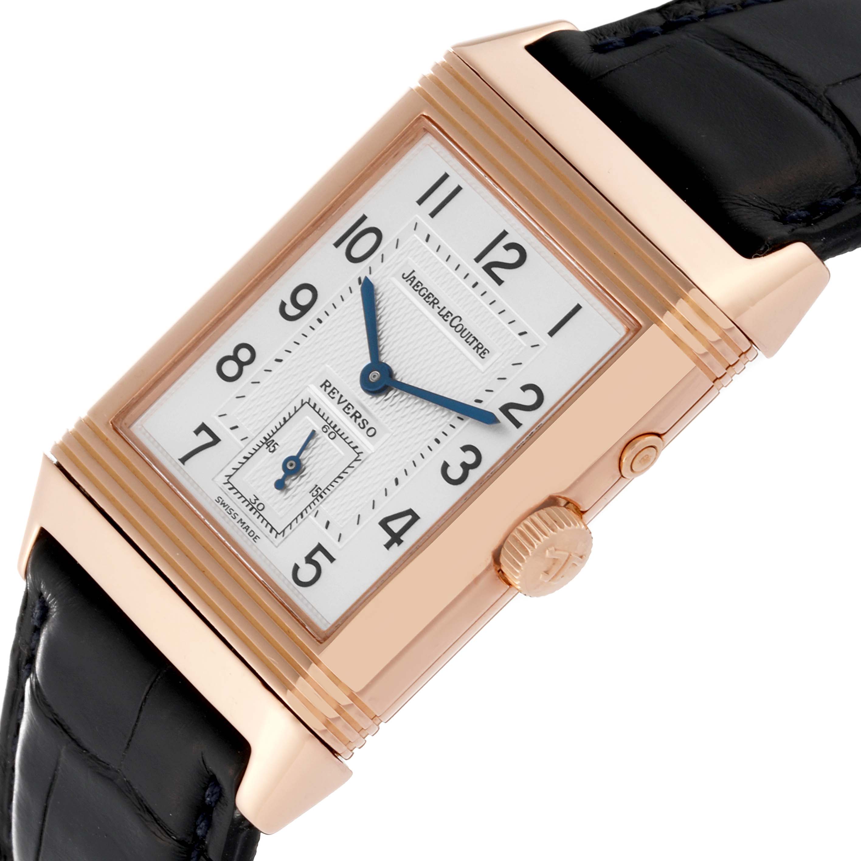 The image shows a Jaeger LeCoultre Reverso Q2712470 Men's Rose Gold Silver Dial Q2712470 Men's Rose Gold Silver Dial watch from a top angle, featuring the face, crown, and part of the strap.
