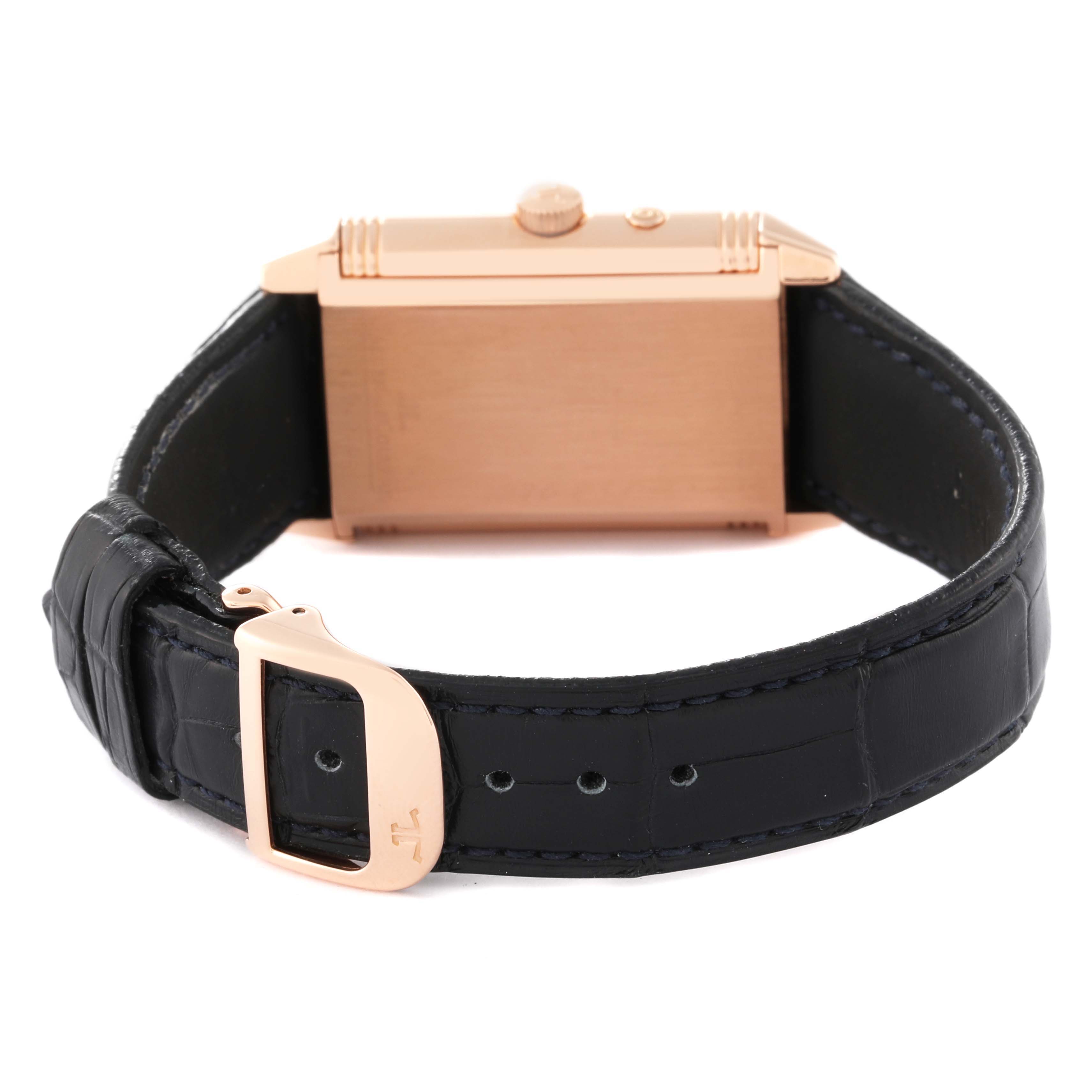 This image shows the back case and part of the strap of a Jaeger LeCoultre Reverso Q2712470 Men's Rose Gold Silver Dial Q2712470 Men's Rose Gold Silver Dial watch, angled to feature the rose gold case and black leather strap.