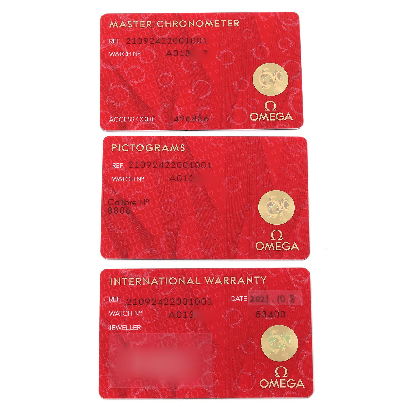 The image shows warranty and authenticity cards for the Omega Seamaster 210.92.42.20.01.001 Men's Titanium Brown Dial 210.92.42.20.01.001 Men's Titanium Brown Dial watch, taken from a top-down angle.