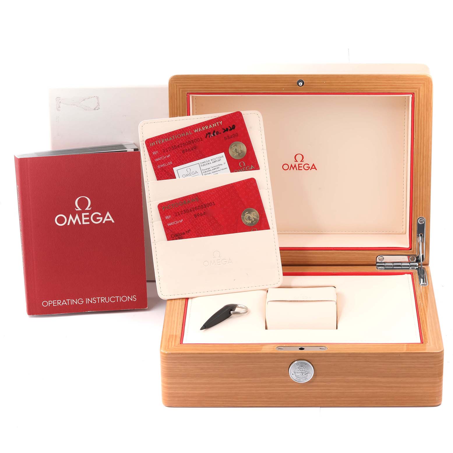 The image shows an open Omega Seamaster 212.30.42.50.03.001 Men's Stainless Steel Blue Dial 212.30.42.50.03.001 Men's Stainless Steel Blue Dial watch box with its operating instructions, warranty cards, and a key.
