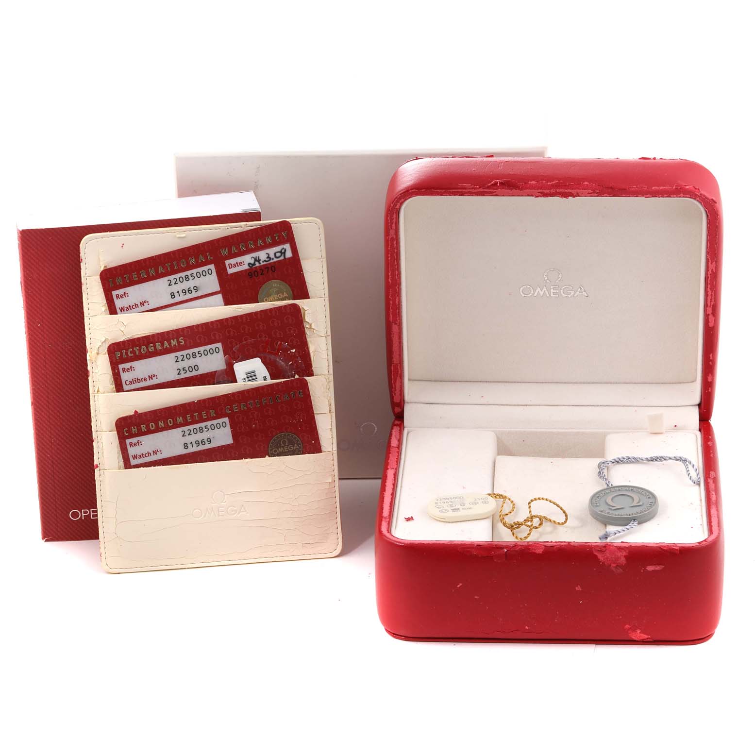 The image shows the accessories for an Omega Planet Ocean 2208.50.00 Men
s Stainless Steel Black Dial 2208.50.00 Men
s Stainless Steel Black Dial, including a red box, warranty cards, and a white cardholder.