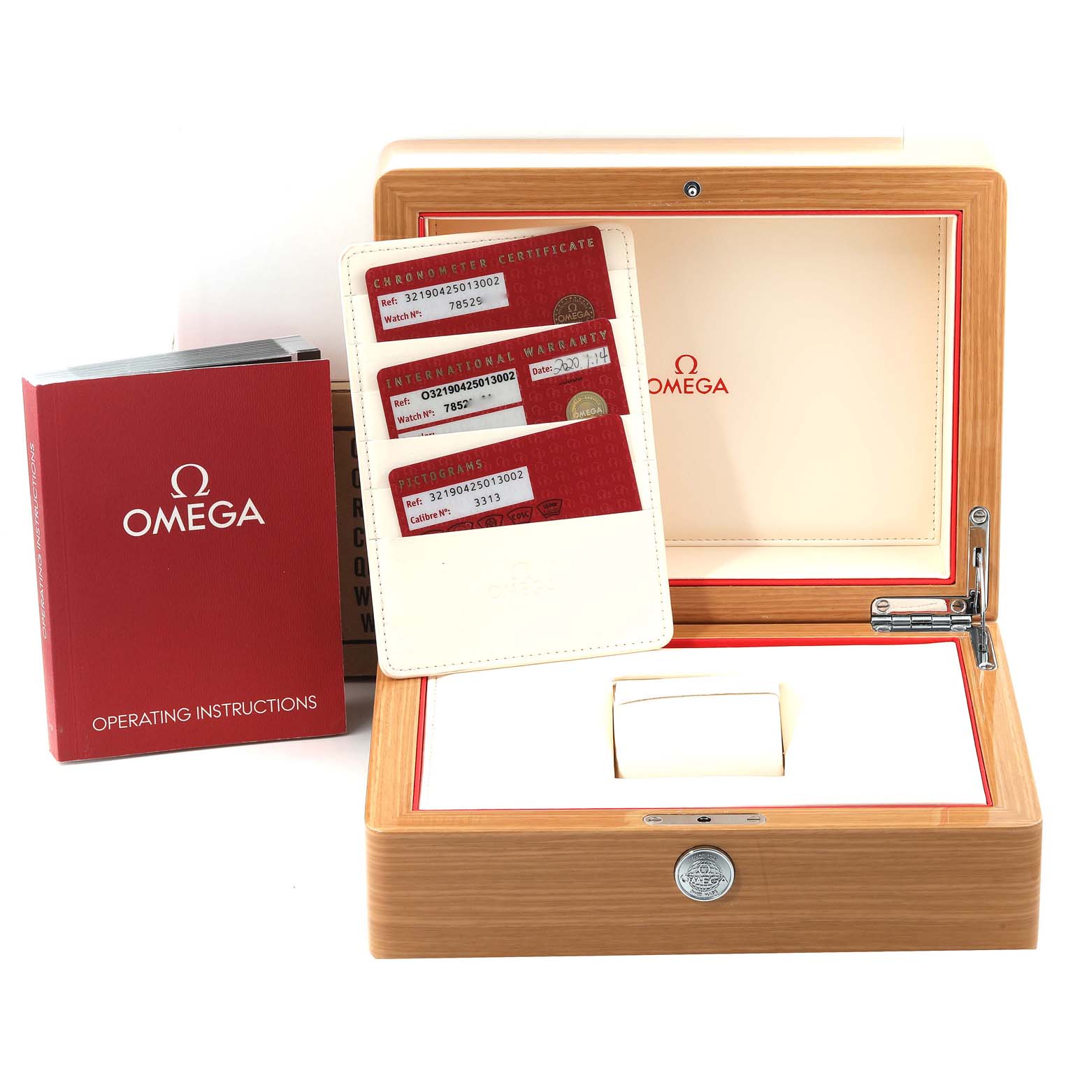 The image shows a wooden box for an Omega Speedmaster 321.90.42.50.13.002 Men's Stainless Steel Brown Dial 321.90.42.50.13.002 Men's Stainless Steel Brown Dial, with instruction booklets and warranty cards displayed.