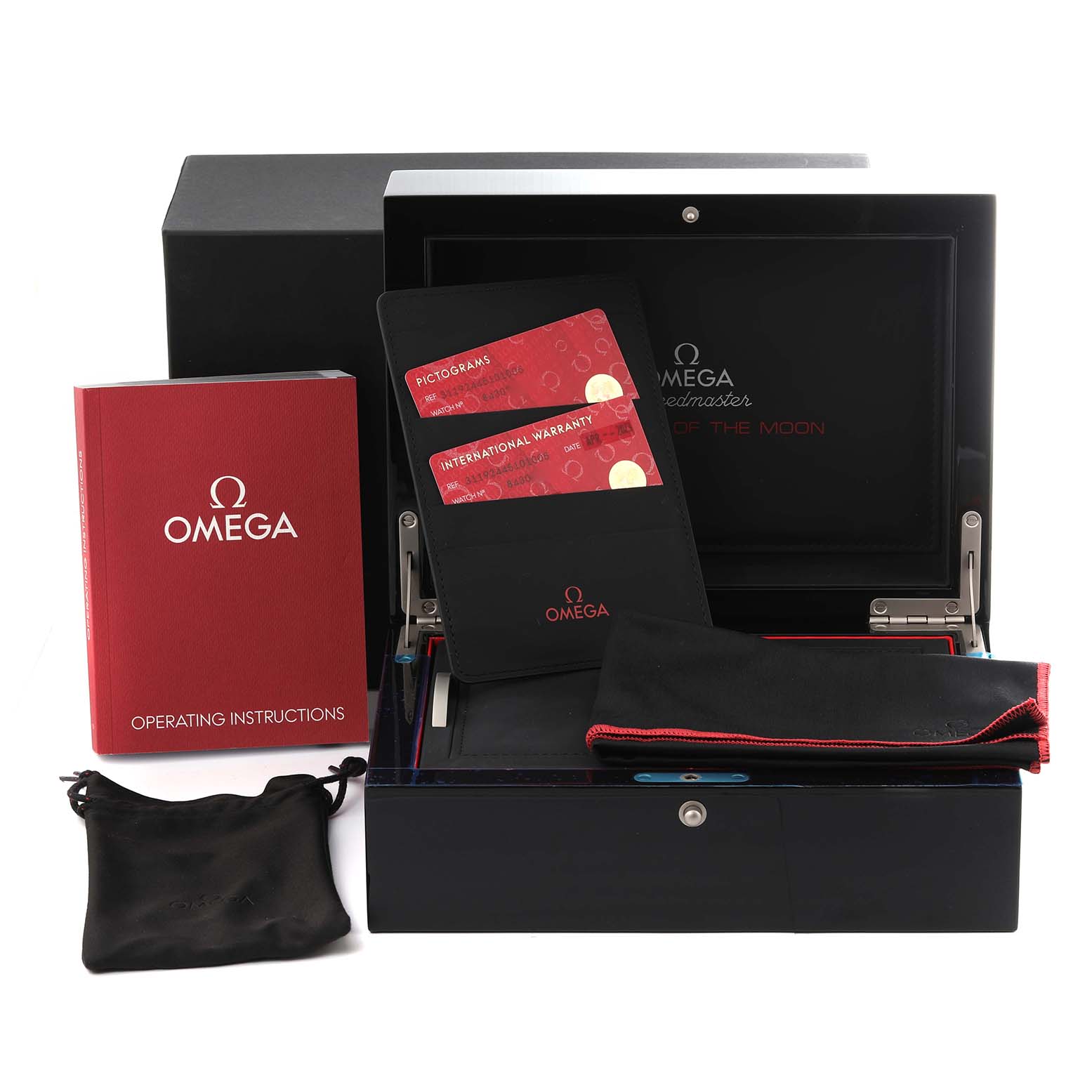 This image shows the accessories for an Omega Speedmaster 311.92.44.51.01.005 Men's Ceramic Black Dial 311.92.44.51.01.005 Men's Ceramic Black Dial, including the box, operating instructions, warranty cards, and a pouch.