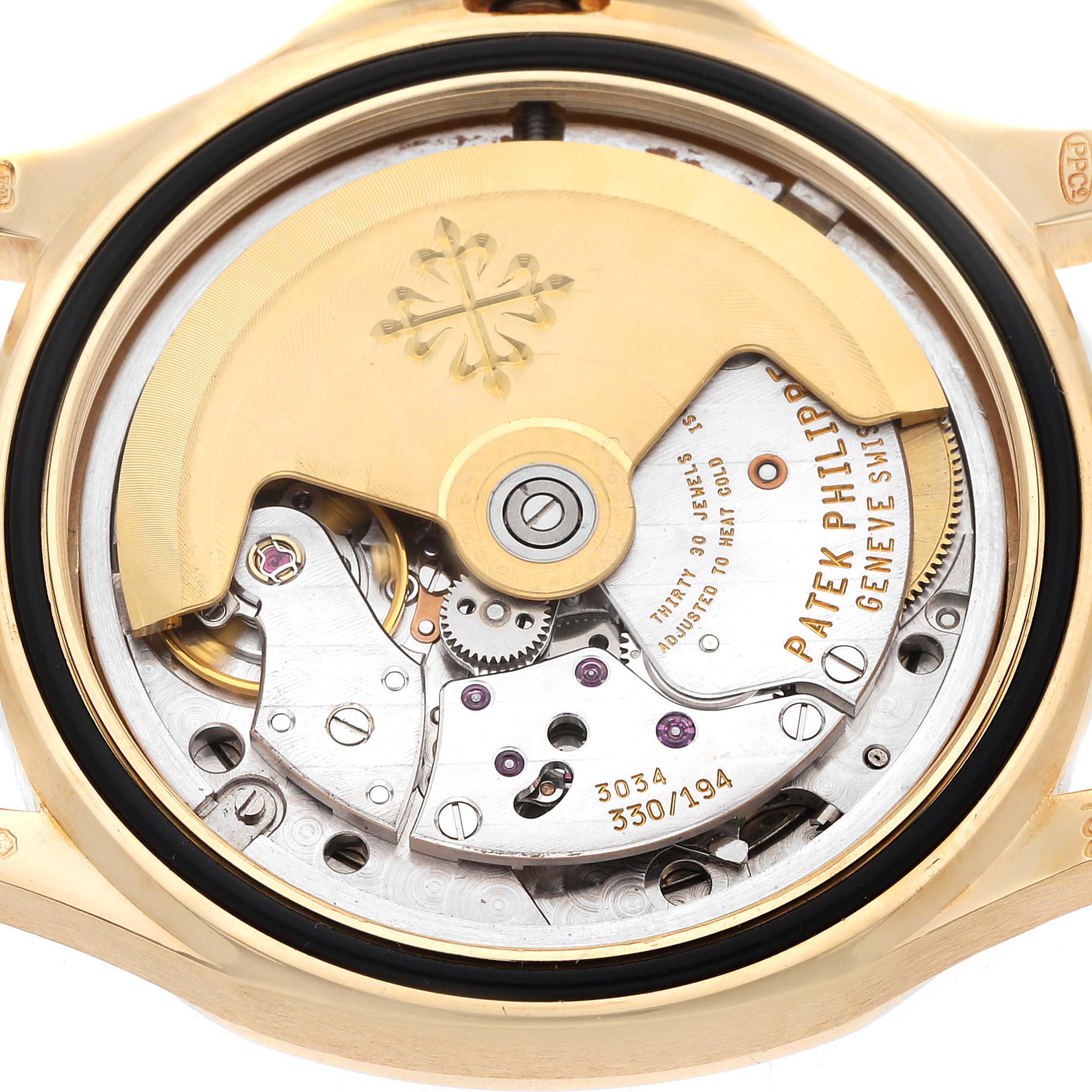 The image shows the movement of a Patek Philippe Aquanaut 5066J Men
s Yellow Gold Black Dial watch from a rear angle, highlighting the rotor and intricate mechanics.