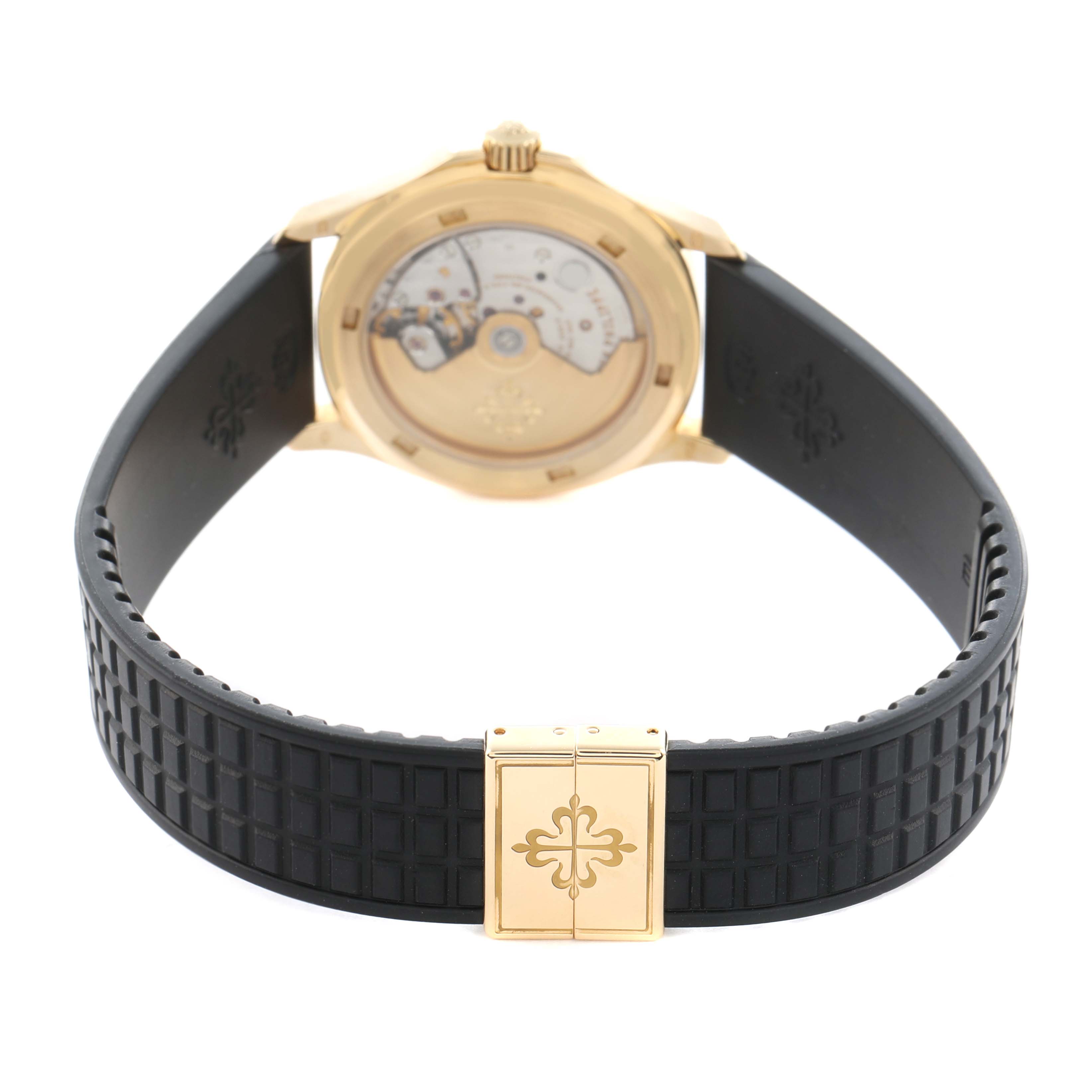 The Patek Philippe Aquanaut 5066J Men
s Yellow Gold Black Dial watch is shown from the back, highlighting the transparent case back and rubber strap with a clasp.