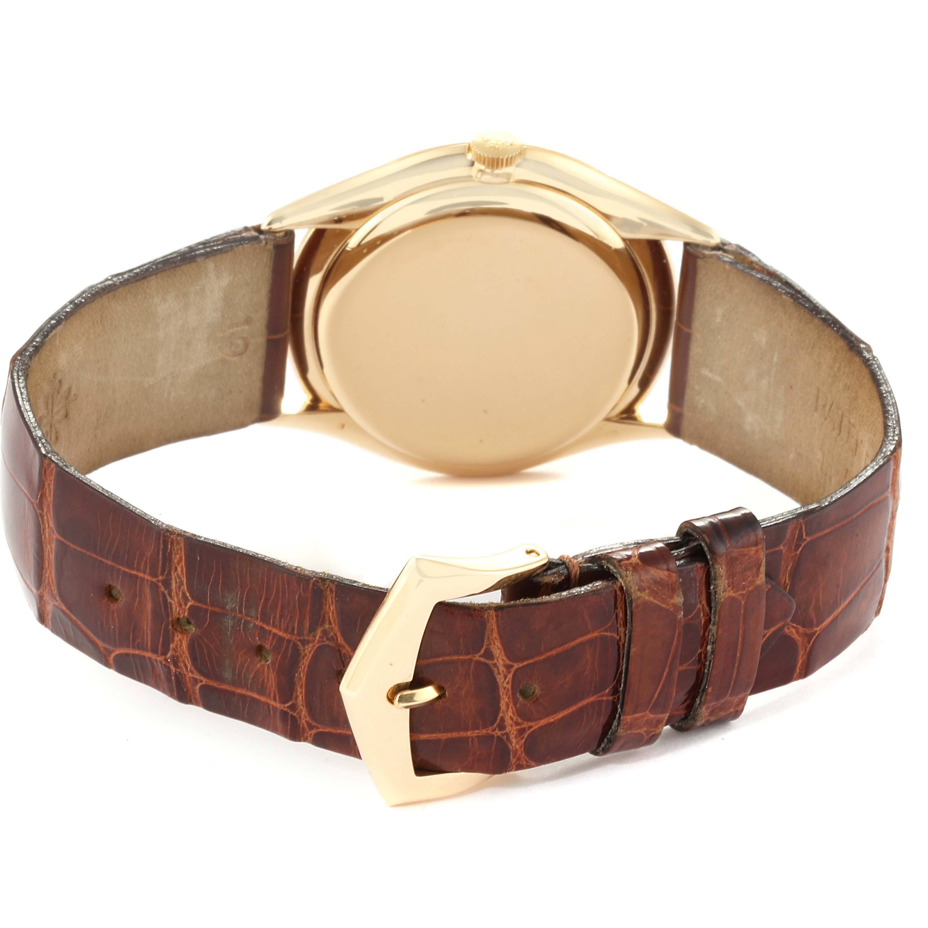 This image shows the back view of the Vintage Patek Philippe watch, highlighting its gold case and brown leather strap with a gold buckle.