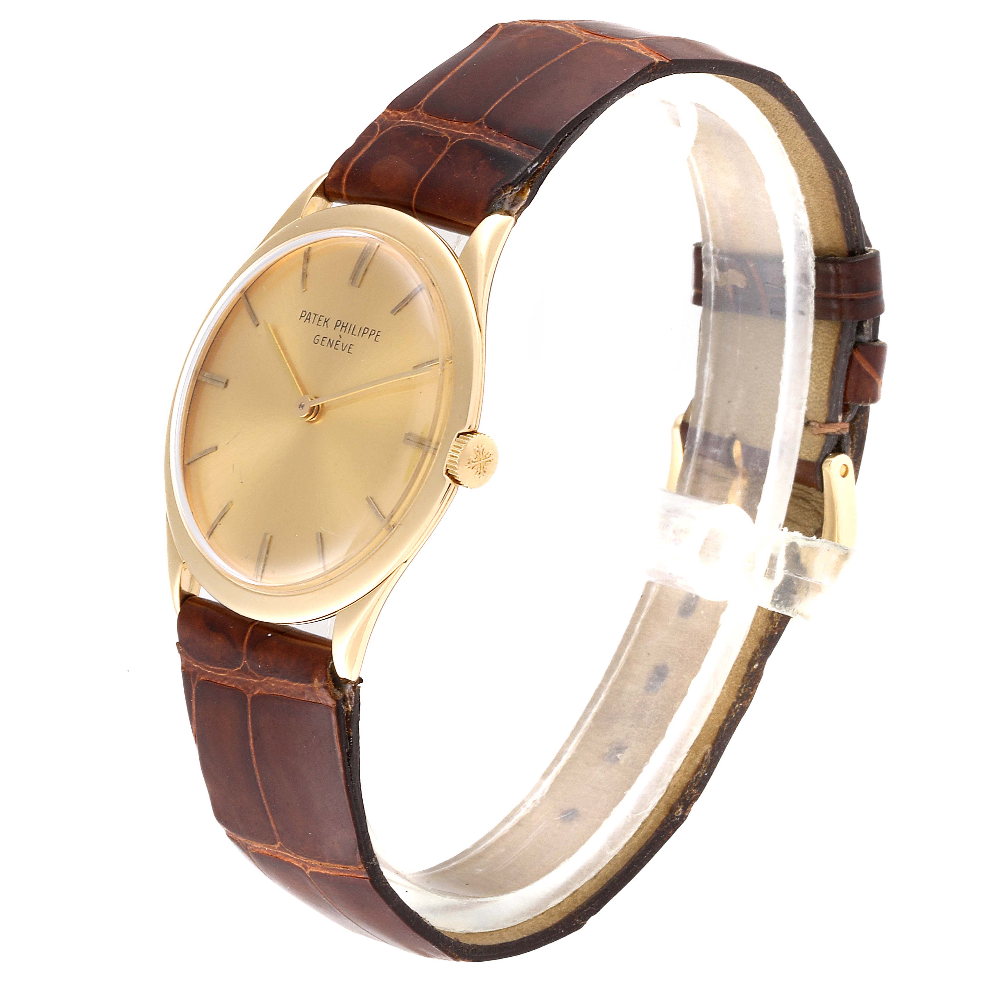 The image shows a Vintage Patek Philippe watch at a slight side angle, highlighting its brown leather strap and gold-tone dial.