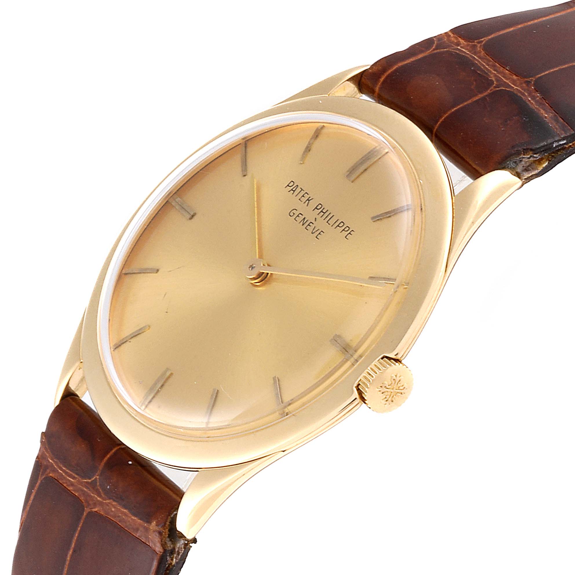 This Patek Philippe Vintage watch is shown at a slight side angle, displaying its gold case, dial, crown, and brown leather strap.