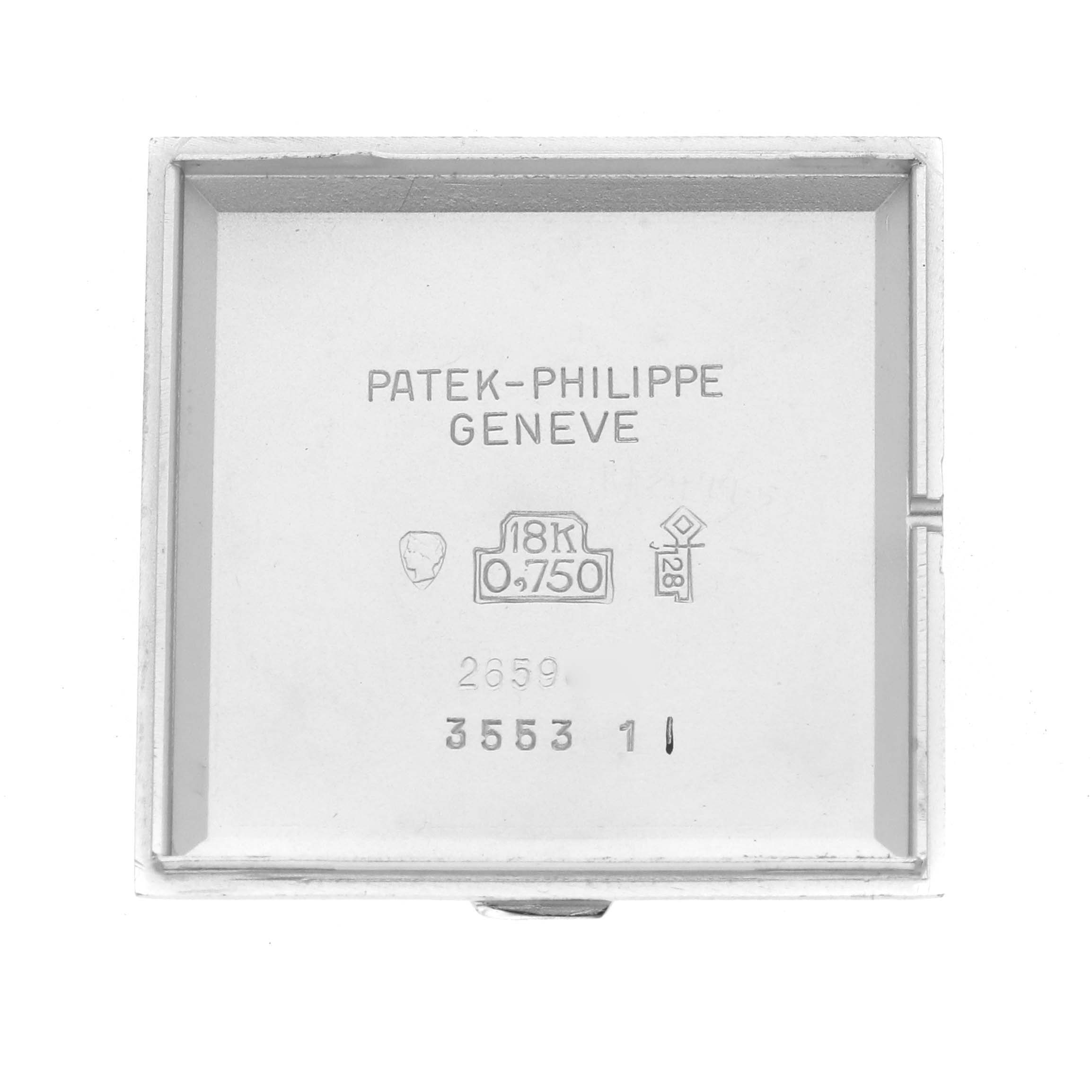 The image shows the inner case back of a Vintage Patek Philippe watch, featuring engravings and hallmark details.