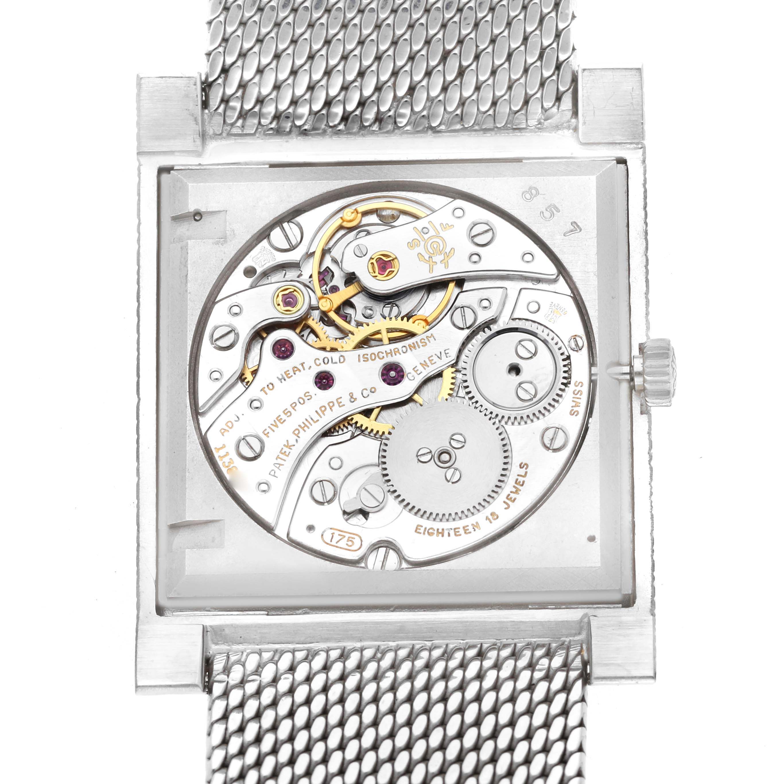 The image shows the movement of a Vintage Patek Philippe watch from the back, highlighting the intricate gears and mechanisms.