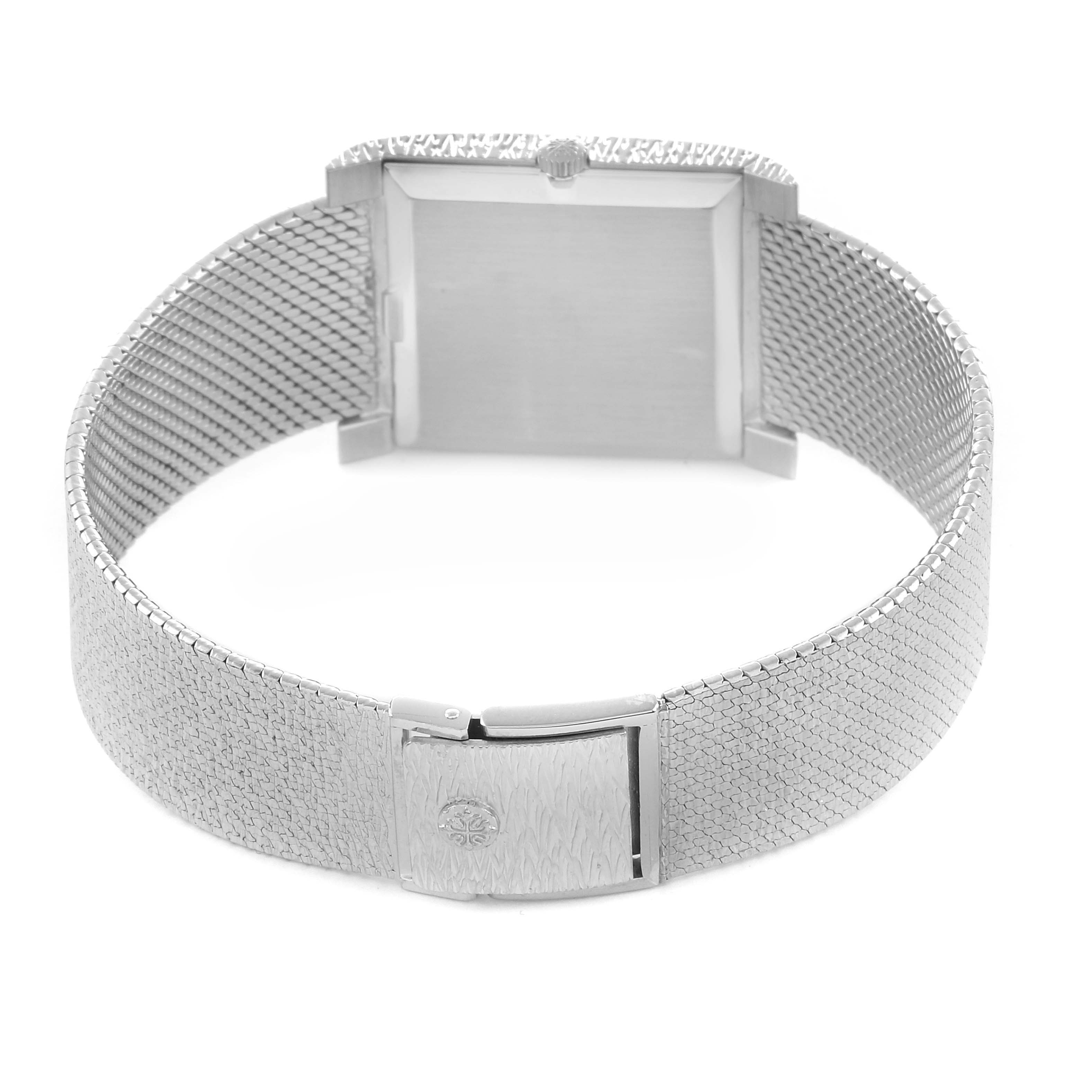 The image shows the back of a Patek Philippe Vintage 3553/1 Men
s White Gold Silver Dial watch, highlighting the clasp and mesh bracelet.