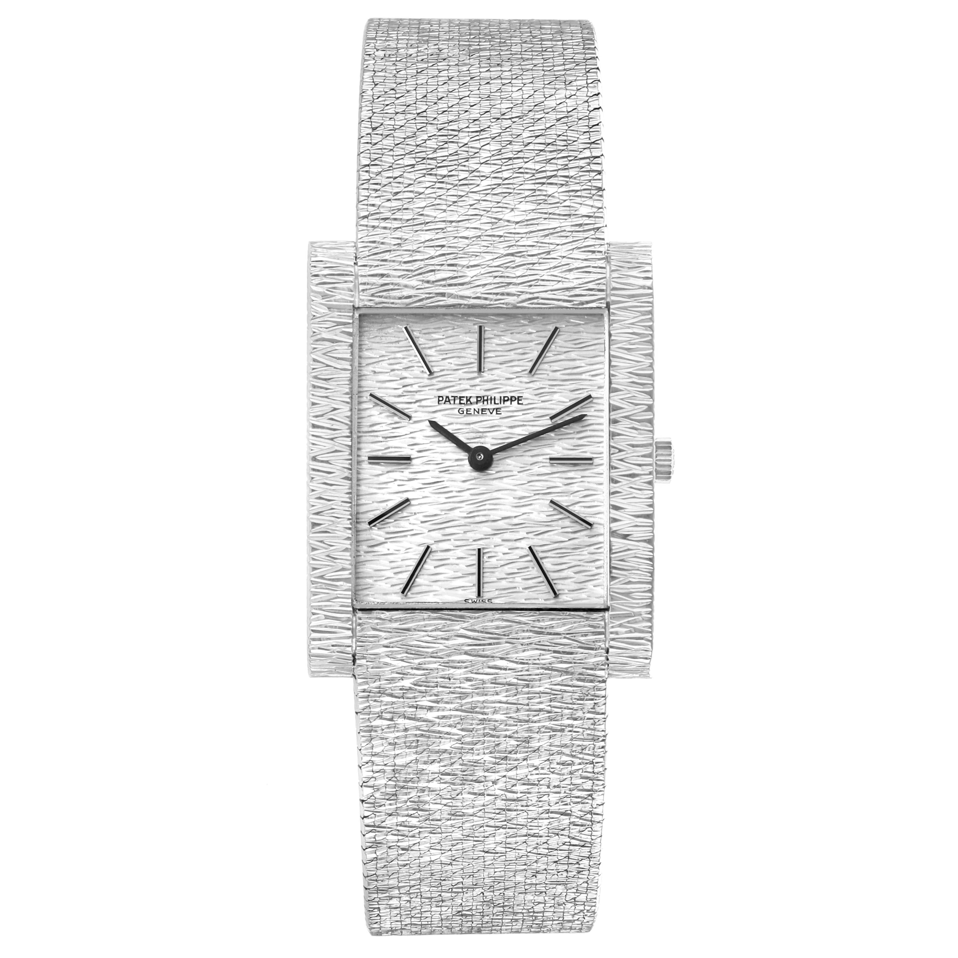 The Patek Philippe Vintage 3553/1 Men
s White Gold Silver Dial watch is shown from a front angle, displaying the textured dial, rectangular case, hands, and bracelet.