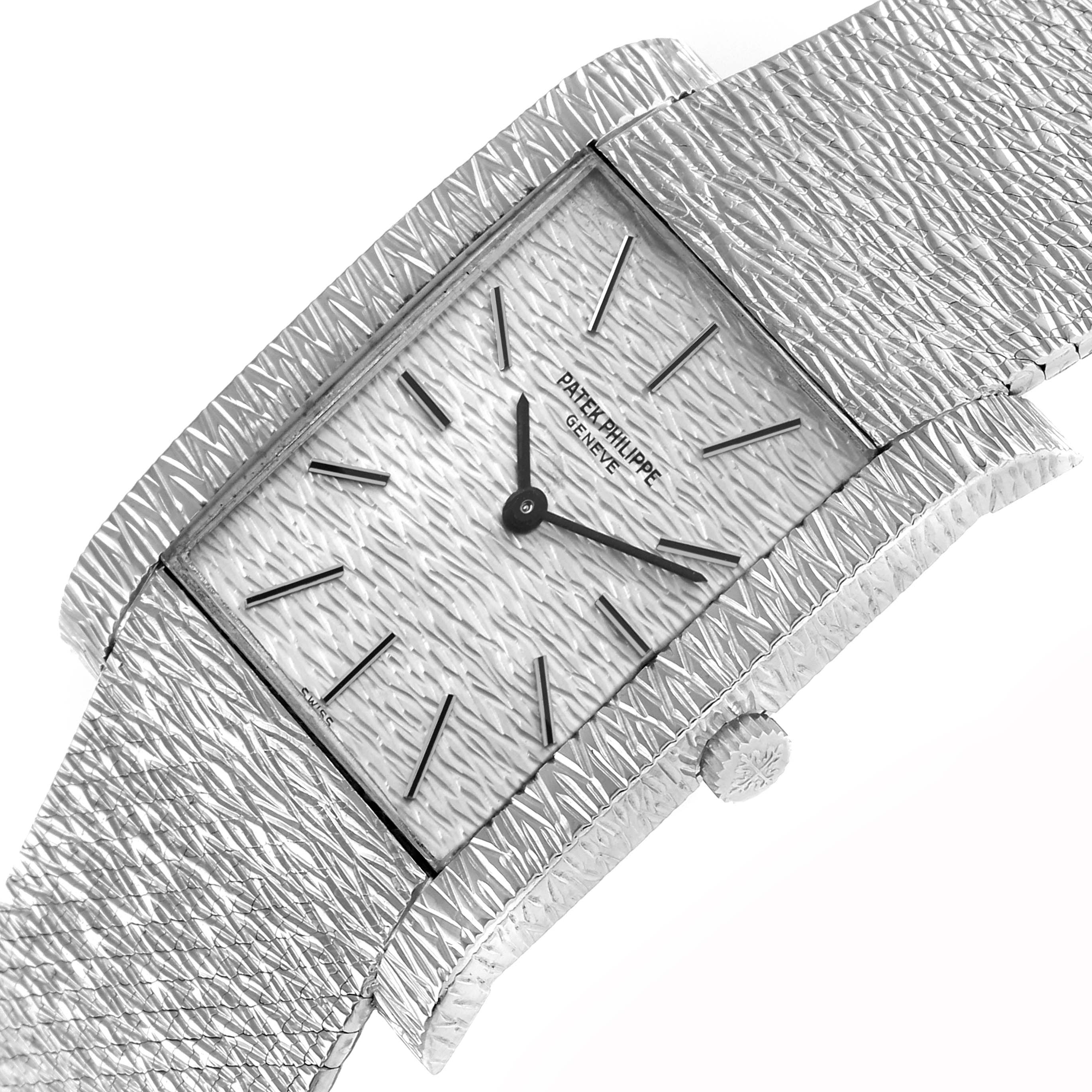 The image shows a Patek Philippe Vintage 3553/1 Men
s White Gold Silver Dial watch at a tilted angle, highlighting the textured rectangular dial, hands, indices, and crown.
