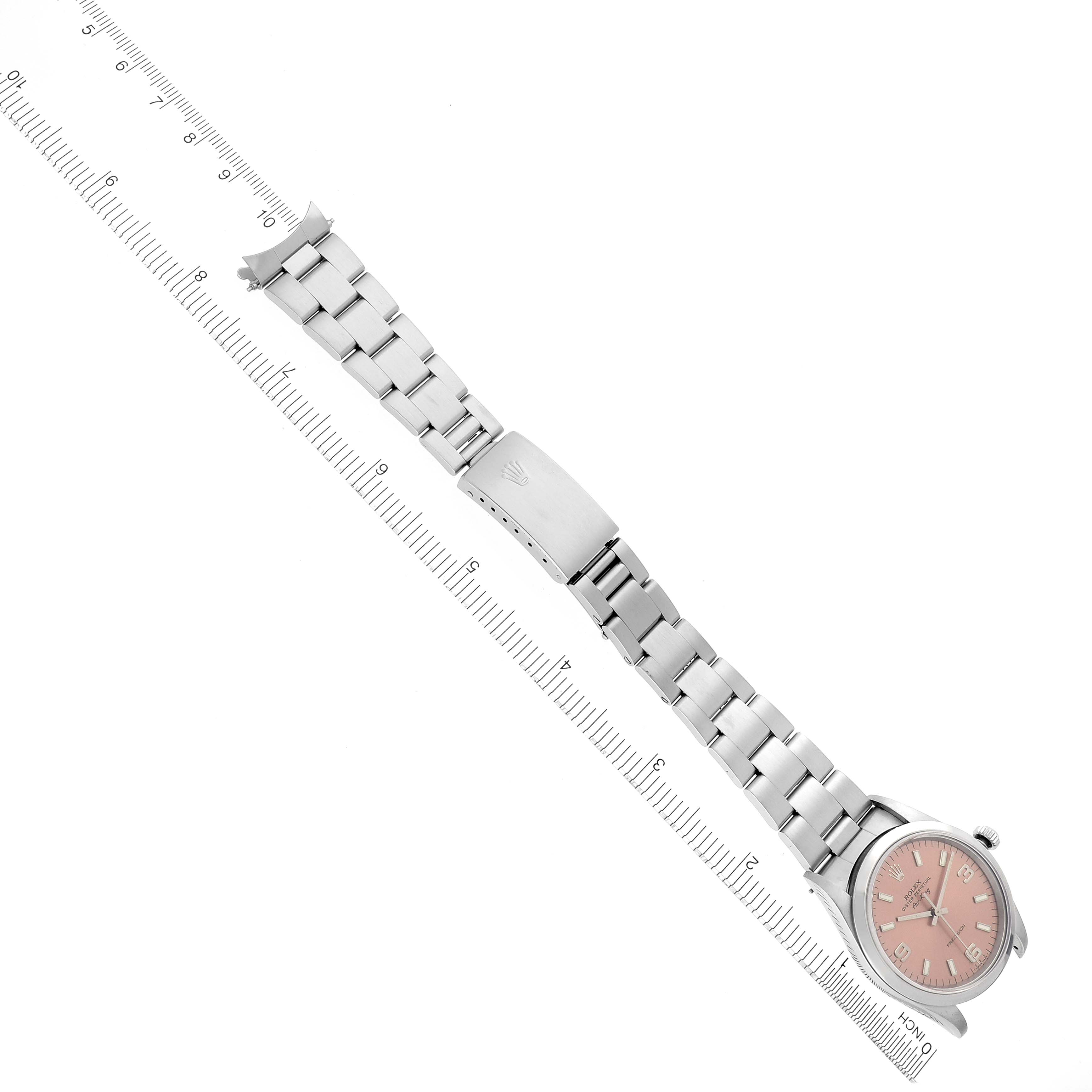 The image shows the Rolex Air-King 14000 Men's Stainless Steel Pink Dial 14000 Men's Stainless Steel Pink Dial watch laid flat, showcasing its pink dial, metal bracelet, and clasp, with rulers on the sides.