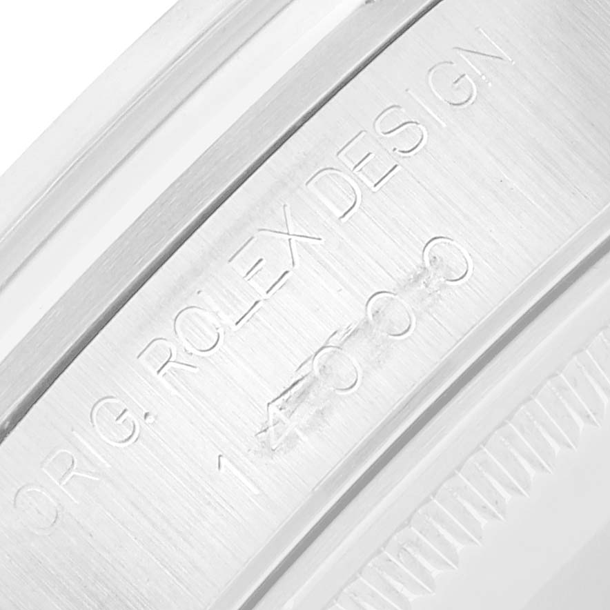 The image shows a close-up of the Rolex Air-King 14000 Men
s Stainless Steel Pink Dial watch casing, highlighting engraved text and serial numbers.