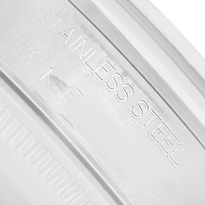 The image shows a close-up of the inner rim of a Rolex Air-King 14000 Men
s Stainless Steel Pink Dial, highlighting the "STAINLESS STEEL" engraving.