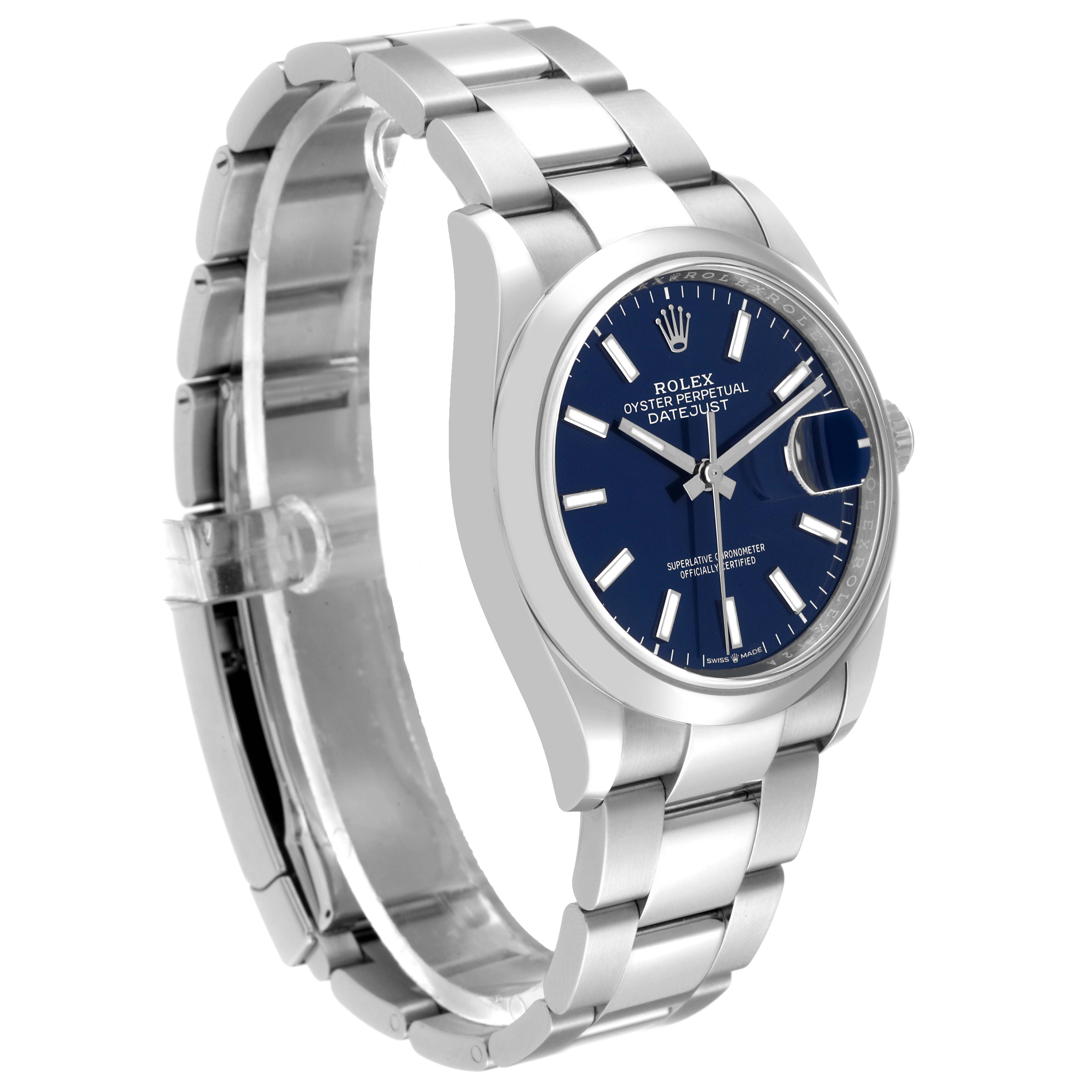 The image shows a Rolex Datejust 126200 Men's Stainless Steel Blue Dial 126200 Men's Stainless Steel Blue Dial watch at a three-quarter angle, highlighting the bracelet, case, and blue dial.