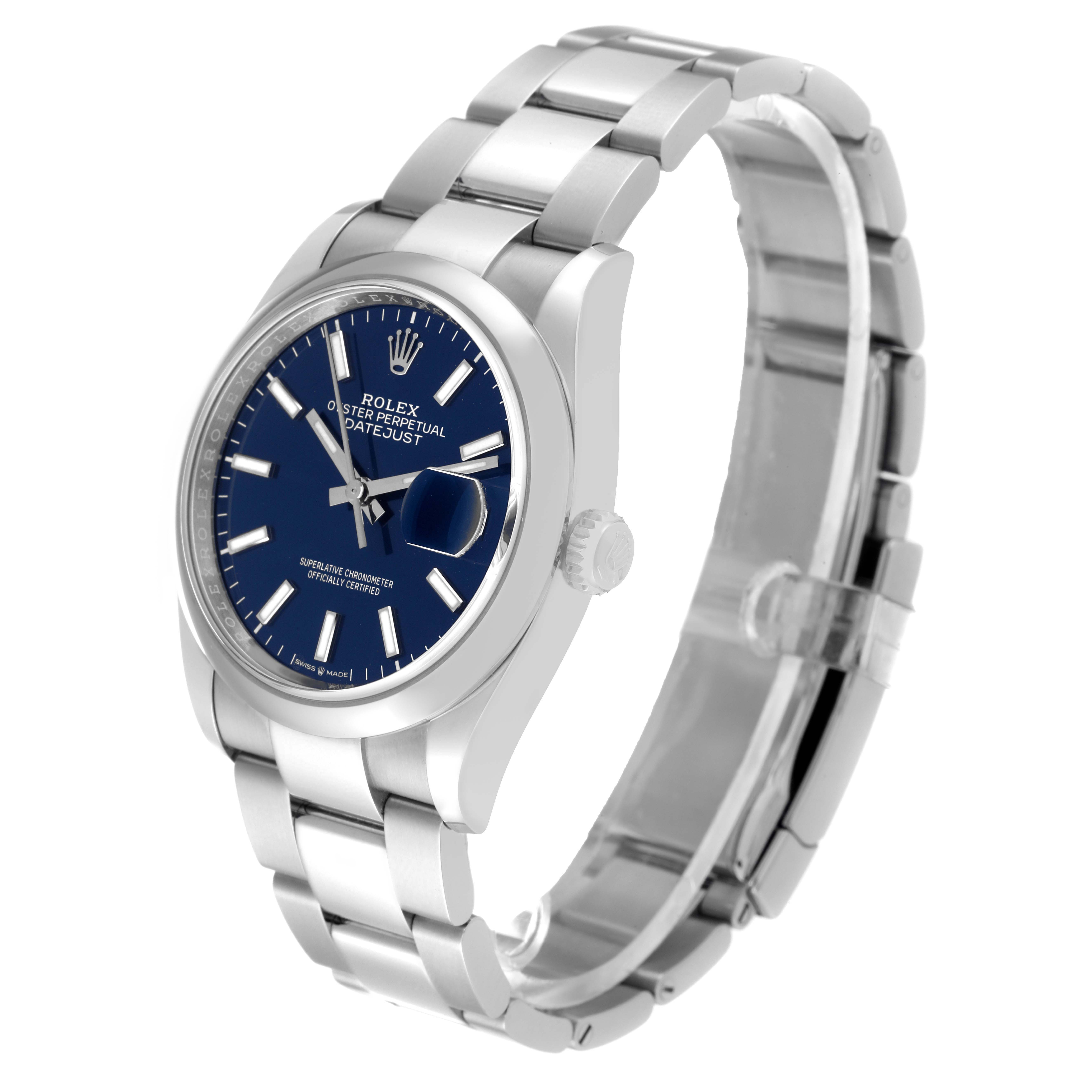 The image shows a Rolex Datejust 126200 Men's Stainless Steel Blue Dial 126200 Men's Stainless Steel Blue Dial watch at an angled side view, highlighting the face, crown, and bracelet.