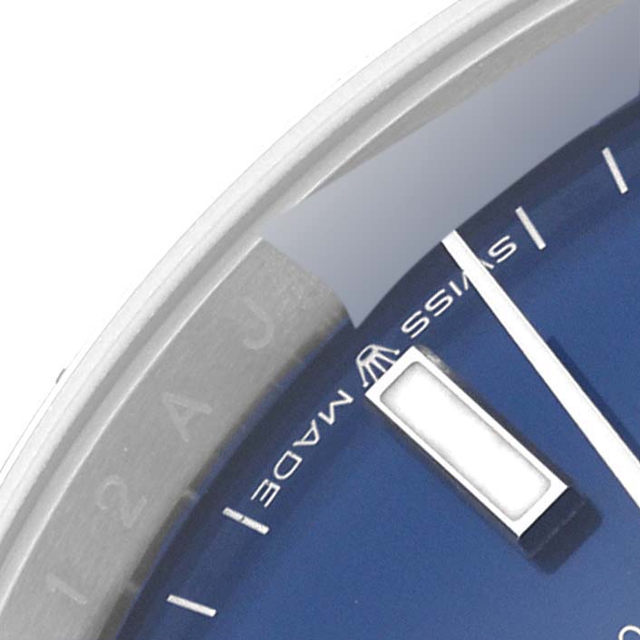 This image shows a close-up of the bezel, dial, and hour marker of a Rolex Datejust 126200 Men's Stainless Steel Blue Dial 126200 Men's Stainless Steel Blue Dial watch.
