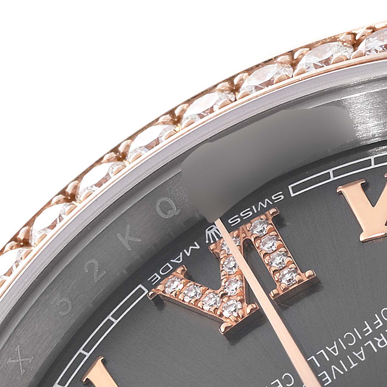 This close-up of the Rolex Datejust 126281 Men
s Steel and Gold (two tone) Grey Dial 126281 Men
s Steel and Gold (two tone) Grey Dial model shows the bezel, part of the dial, and Roman numerals, highlighting intricate details and diamonds.